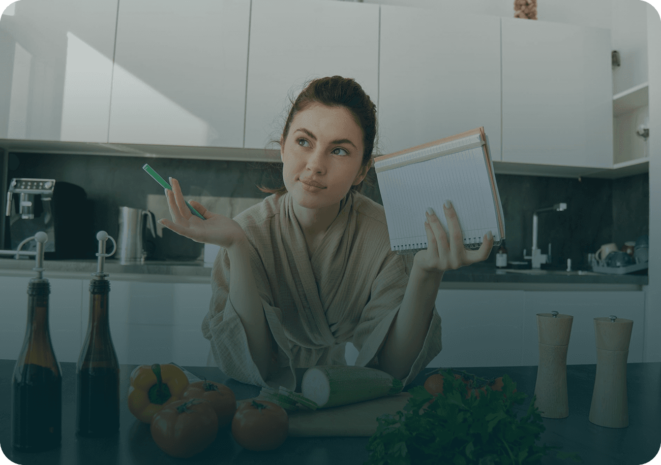 Young sporty woman with scales and vegetables at the kitchen