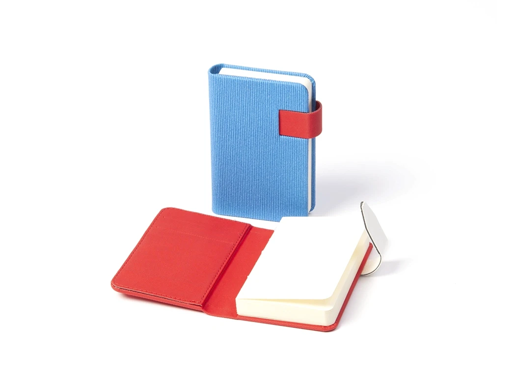 Compact fabric-covered notebook with elastic-style strap and rounded corners