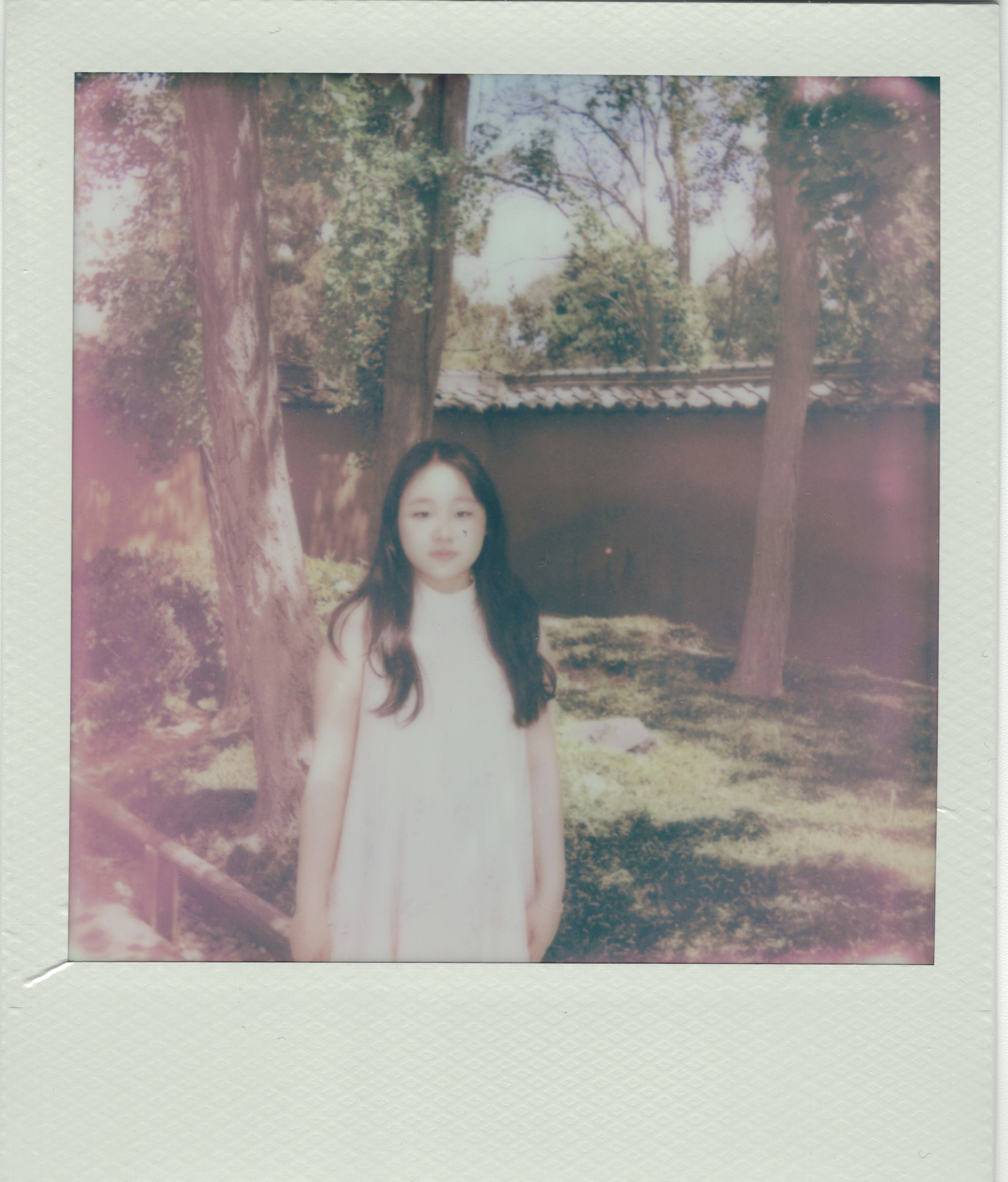 A smiling woman writing on a piece of paper in her home