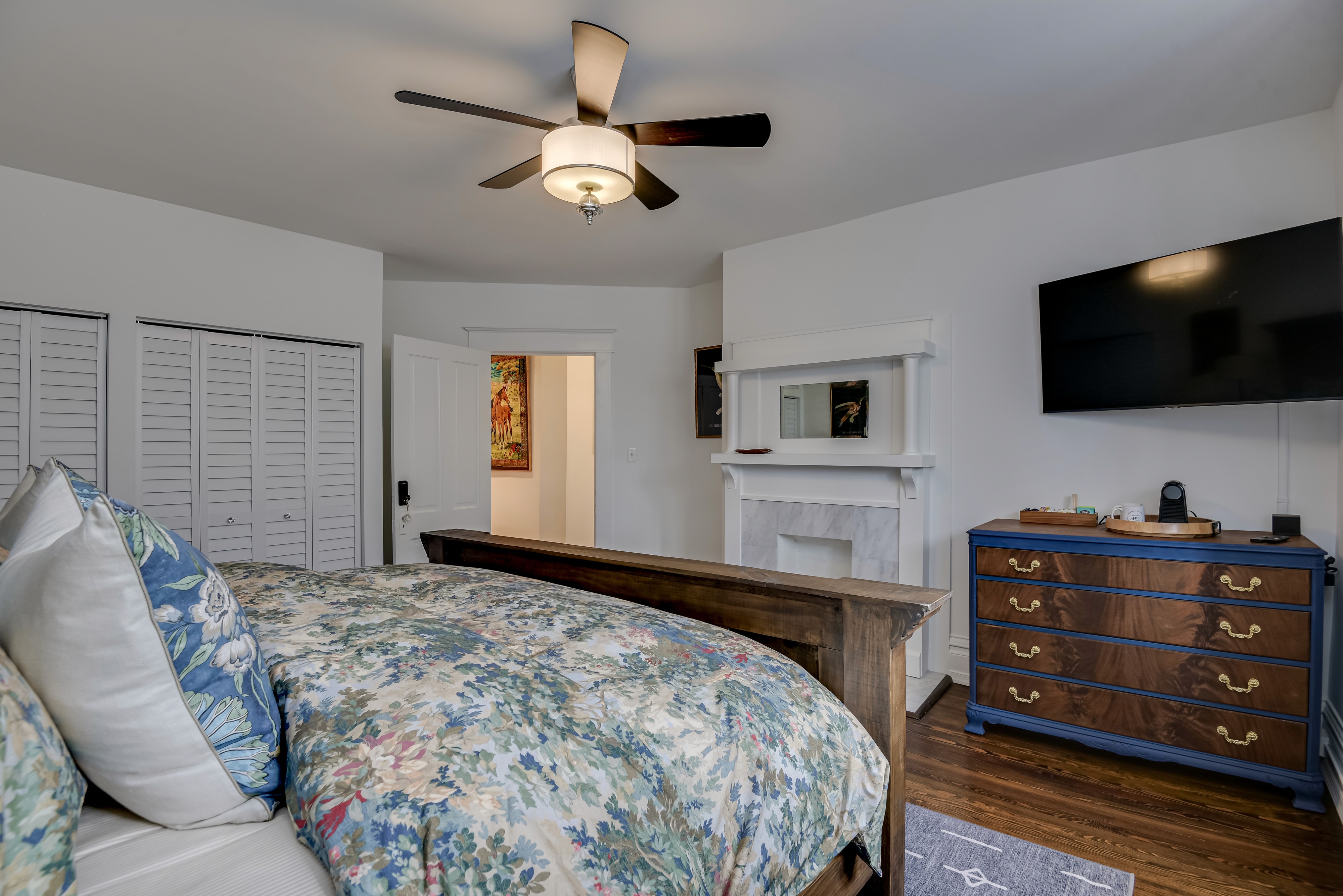 Indulge in the comfort of your spacious king panel bed, dressed in sumptuous linens and cozy blankets, complemented by a plush footboard bench for ultimate relaxation. Unwind in a tranquil sitting area bathed in natural light from grand windows, savoring a freshly brewed morning espresso or a glass of wine as the evening sets in.