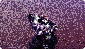 A sparkly diamond shines on a purple background.