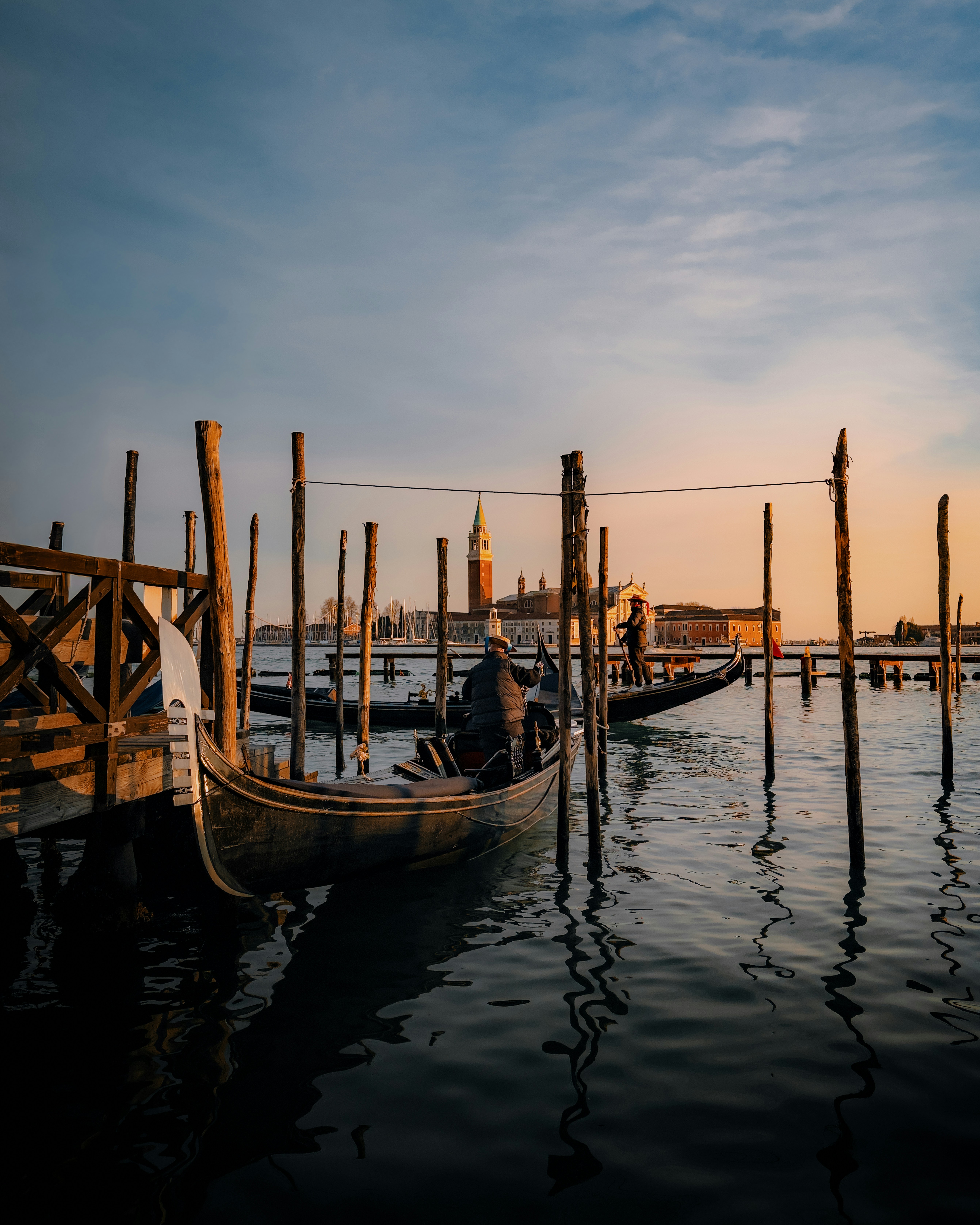 Gondolas docked in venice at sunset