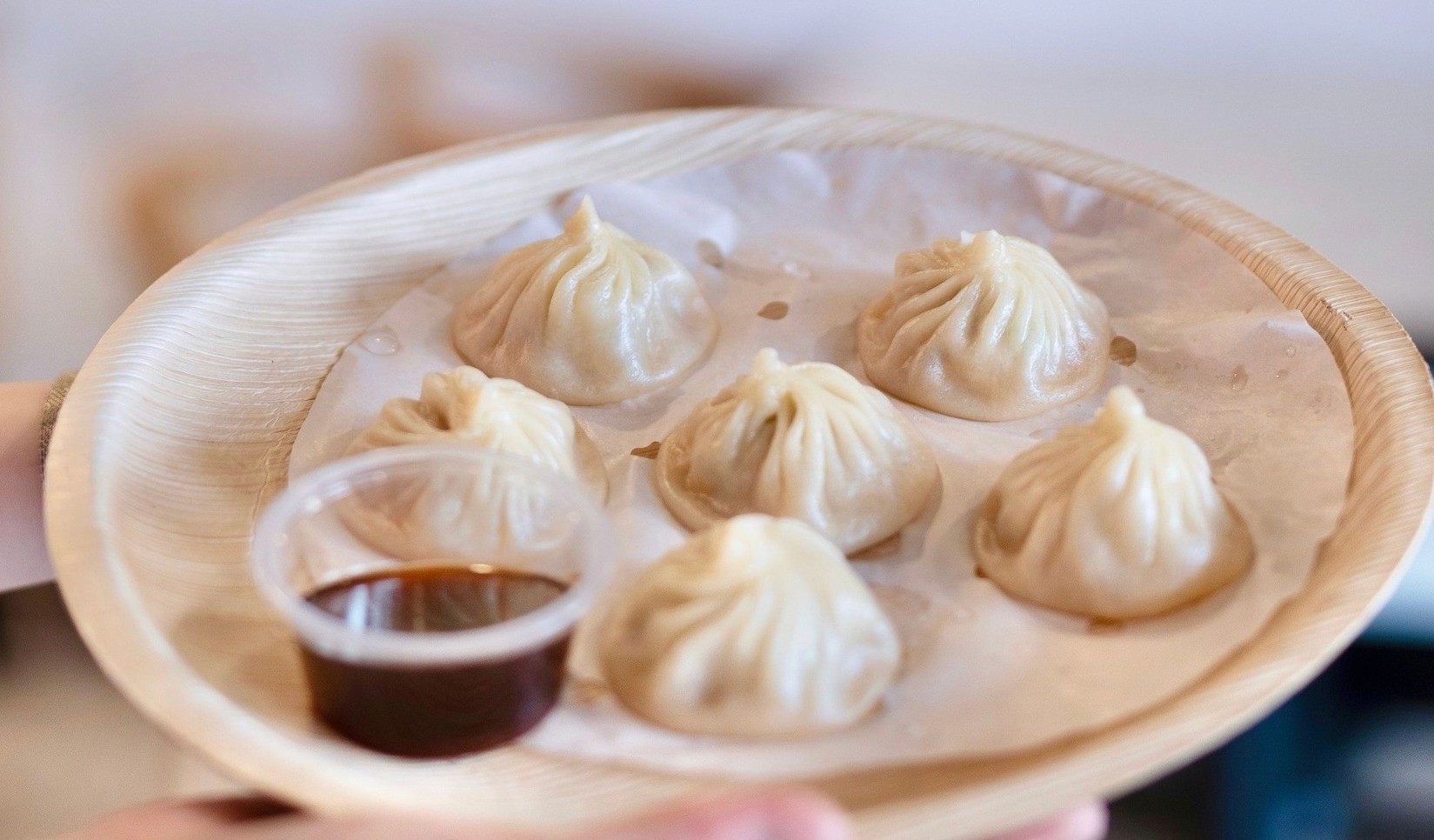 Handmade Soup Dumplings from Everspring – Steaming fresh soup dumplings with delicate, handmade wrappers, served in a traditional bamboo steamer at Everspring Modern Chinese.