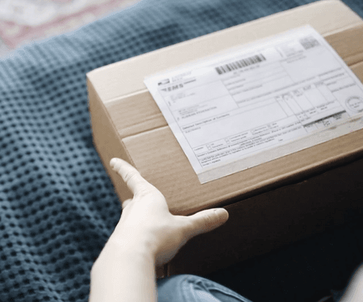 a person holding a pair of black shoes