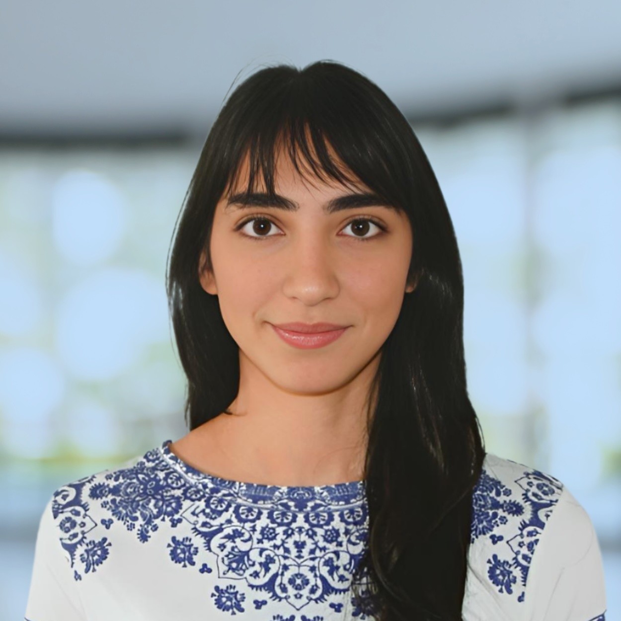 woman in black crew neck t-shirt wearing brown framed eyeglasses standing on rocky shore during
