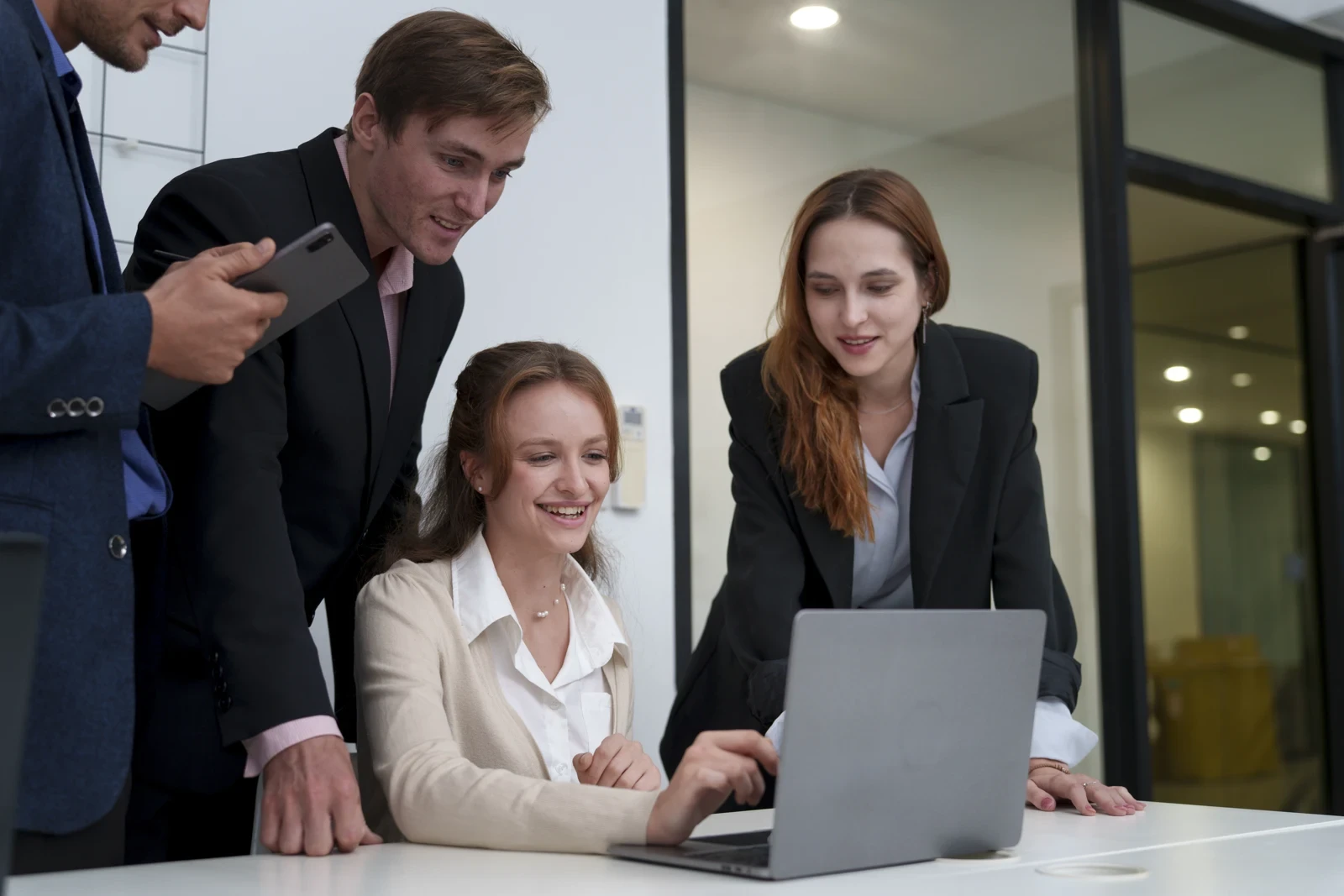 Business colleagues planning a project together around a laptop