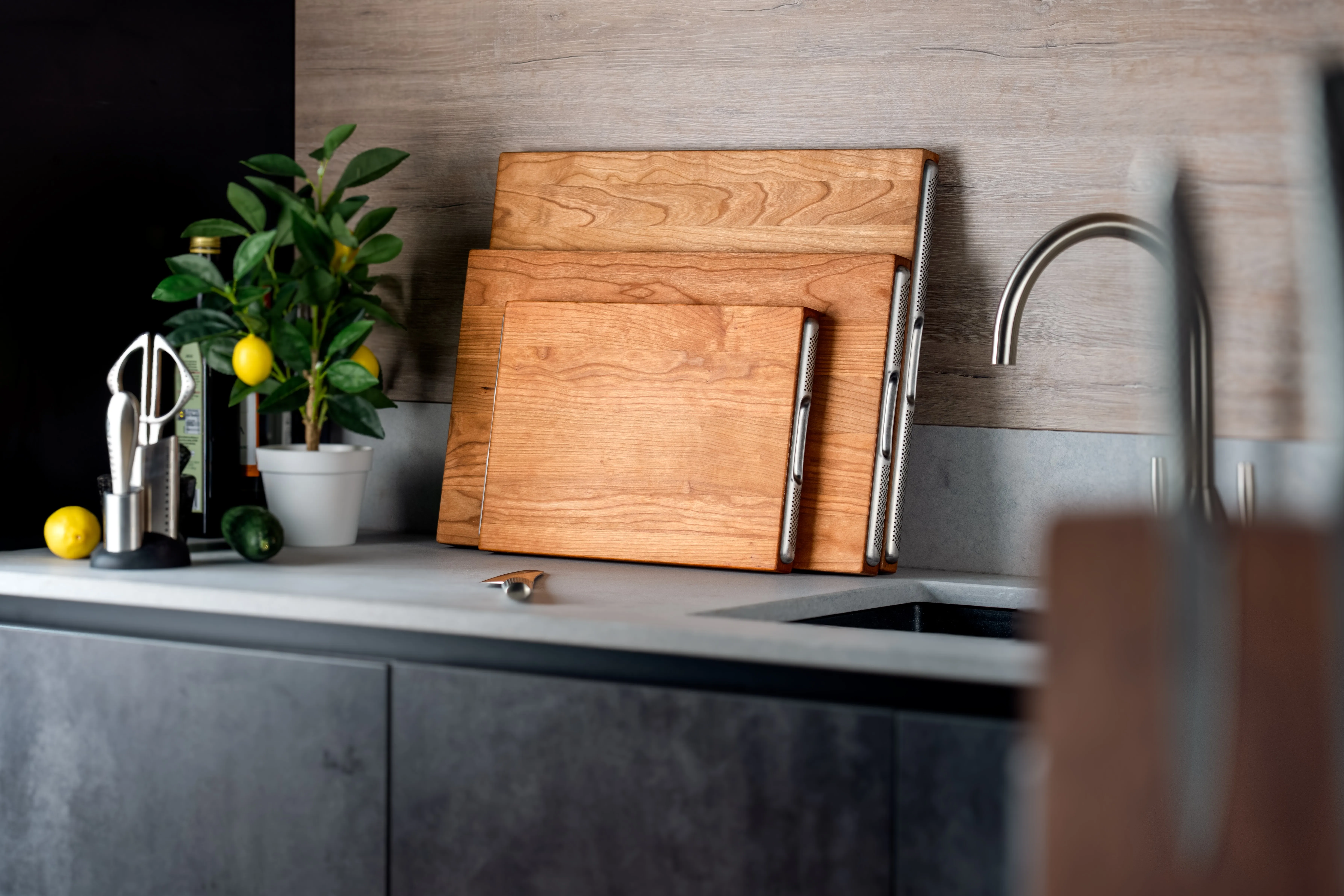 GLOBAL cherry wood chopping boards styled in a modern kitchen with stainless steel handle details