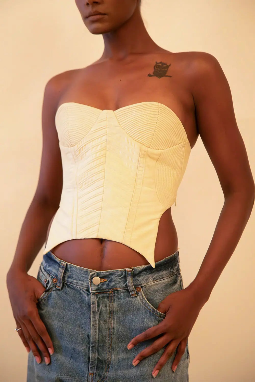 Off-white strapless corset featuring cording detail, handcrafted from upcycled vintage fabric, designed for a structured fit and conscious style