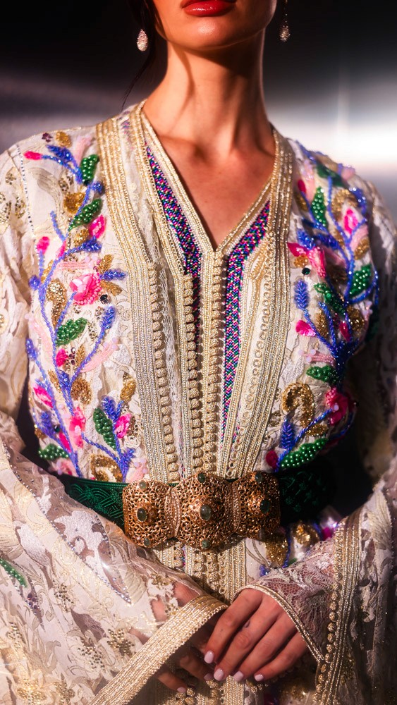 Ivory Moroccan caftan with colorful floral embroidery, handcrafted luxury piece for elegant events in Bahrain