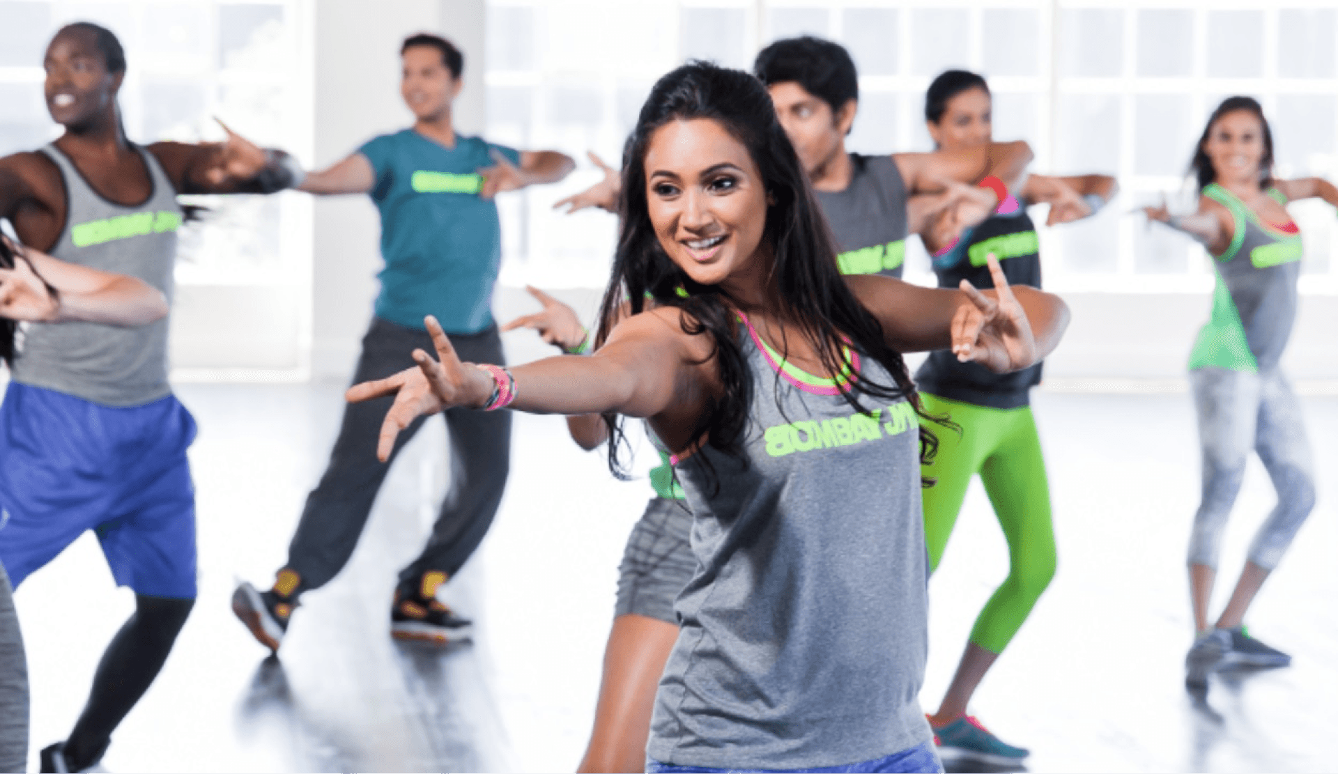 Group Zumba class with energetic participants, demonstrating fun fitness ideas for wedding season.