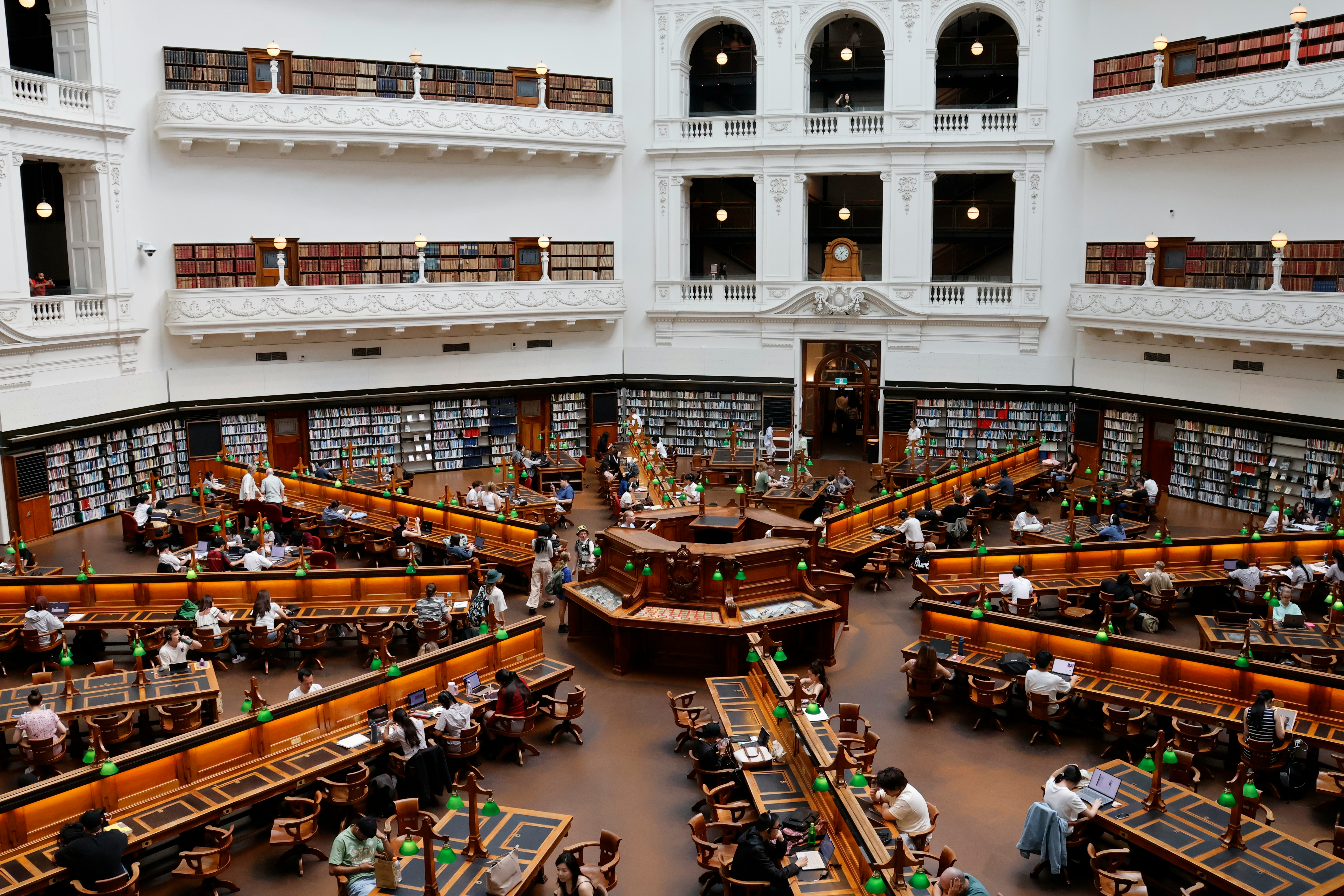 Grand library interior with many people reading
