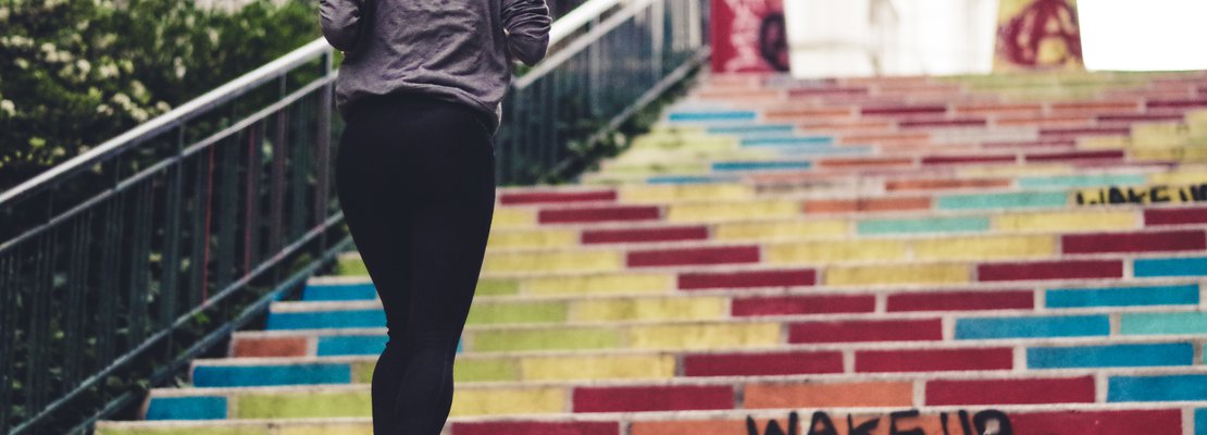 A woman facing the stairway