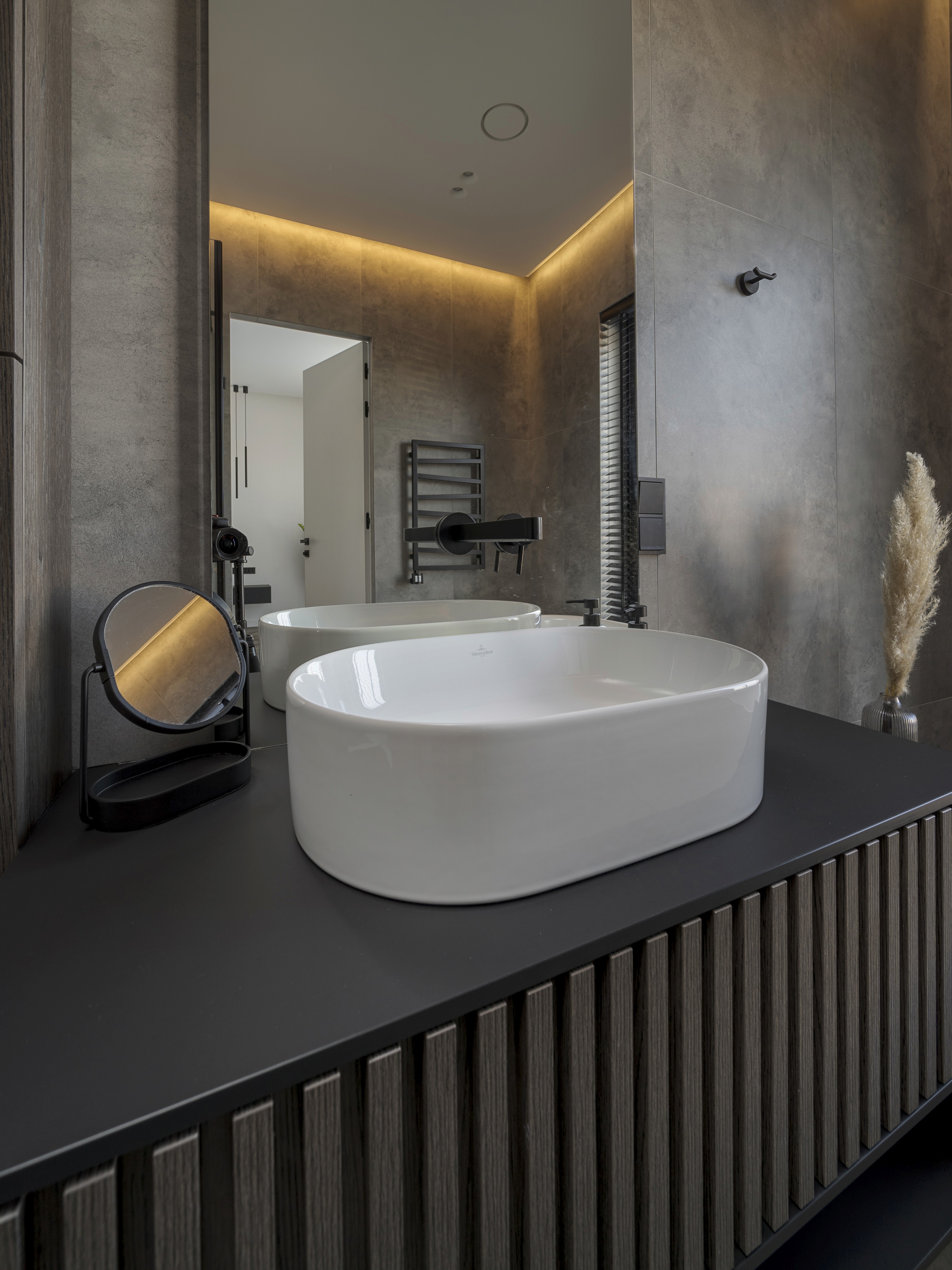 Woman in red outfit poses by a red telephone booth.