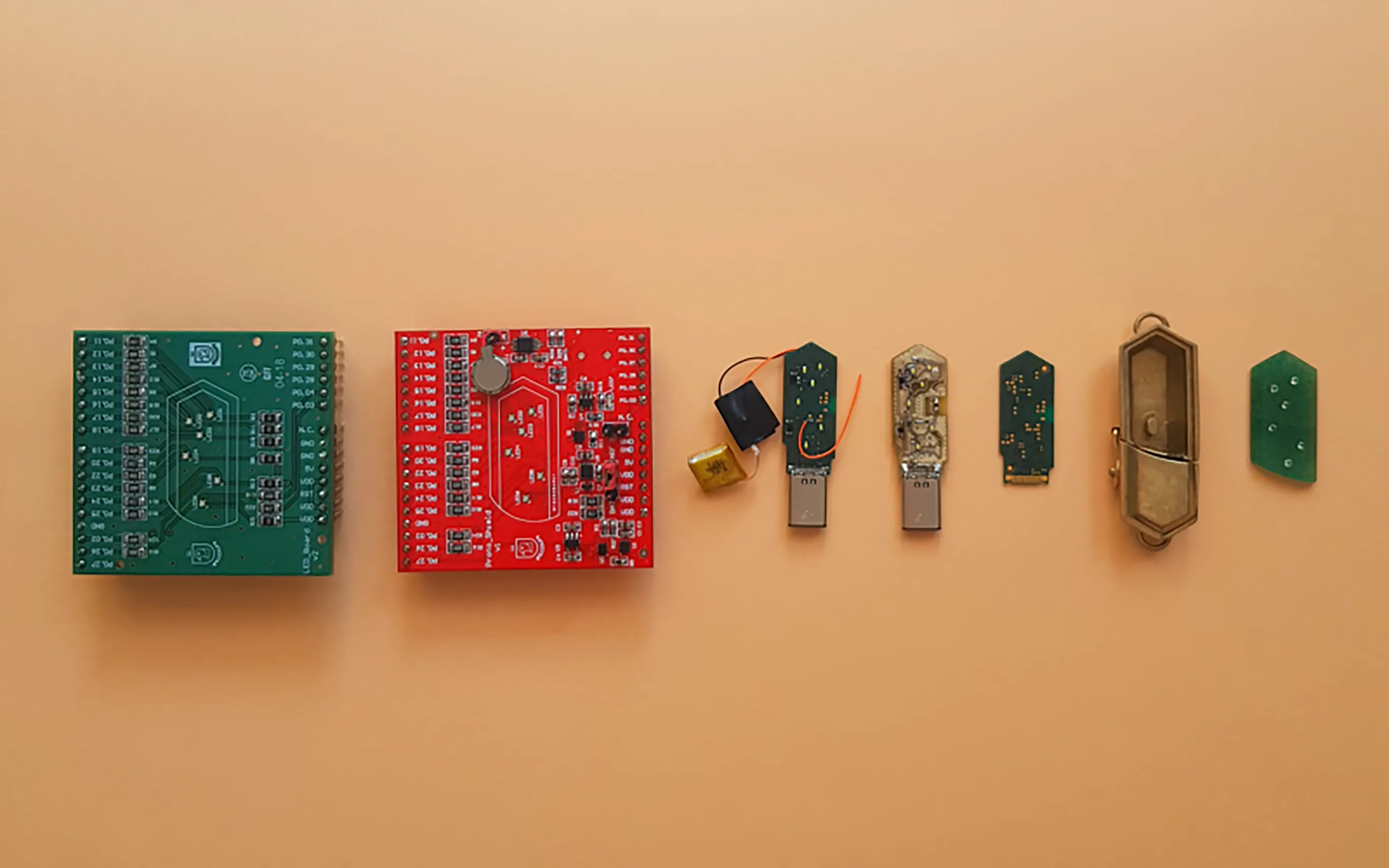 Talsam smart jewelry electronics, circuit boards, batteries, and enclosure components arranged in development stages