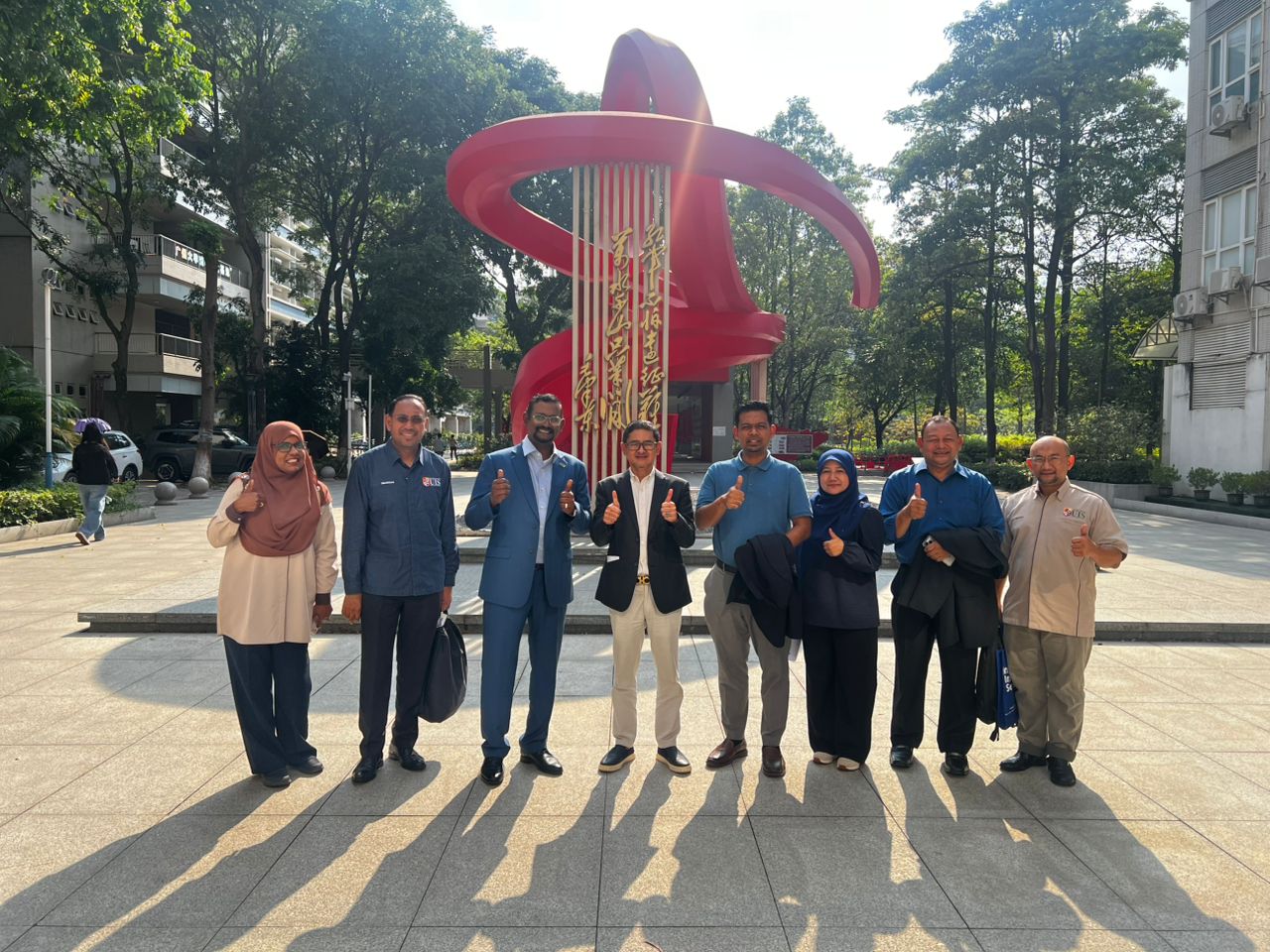 Joint group photo of UIS and HYEDU representatives at the HYEDU Foshan office lobby following the formalisation of the strategic partnership