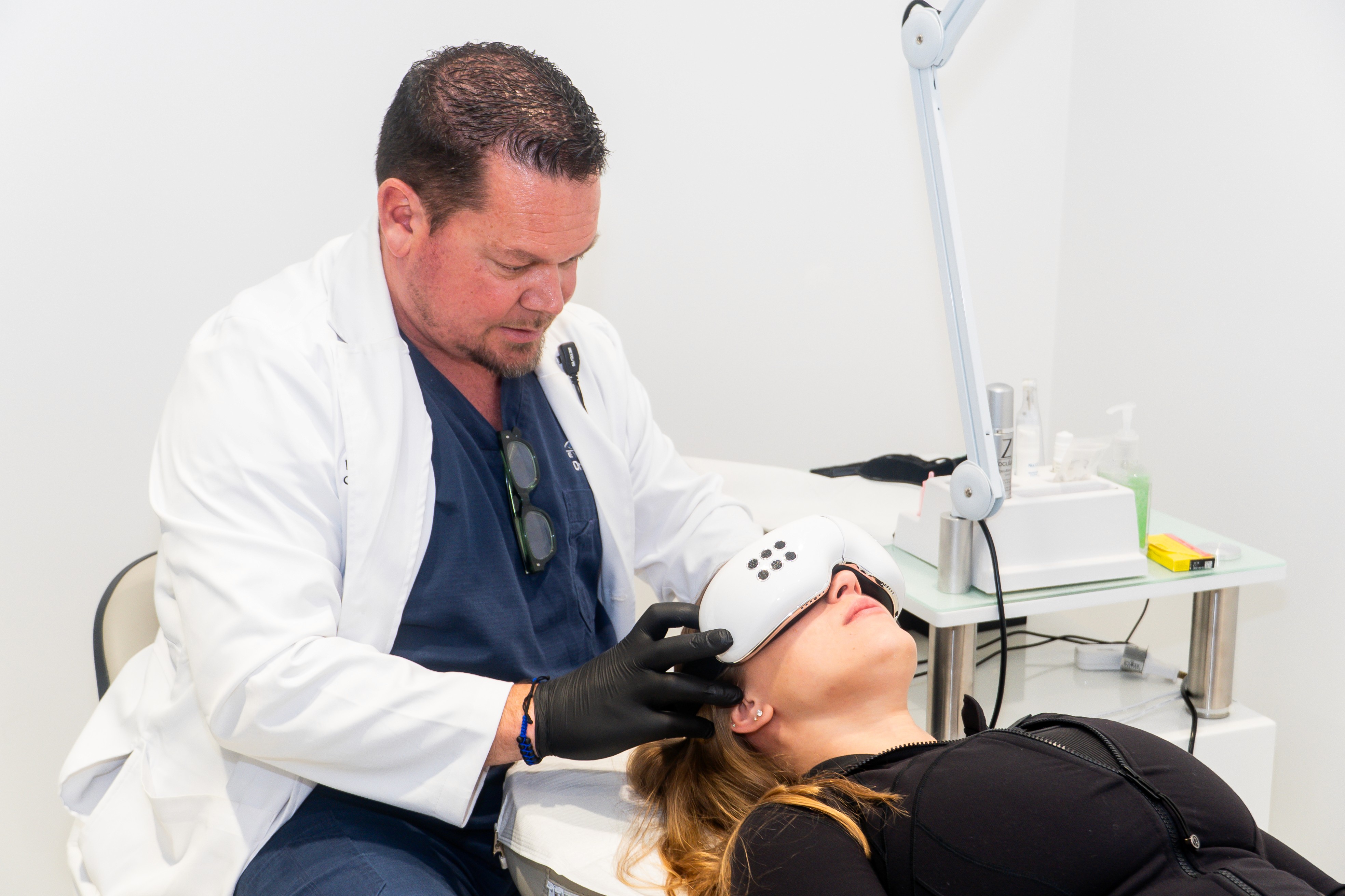 Patient looking through an eye examination machine