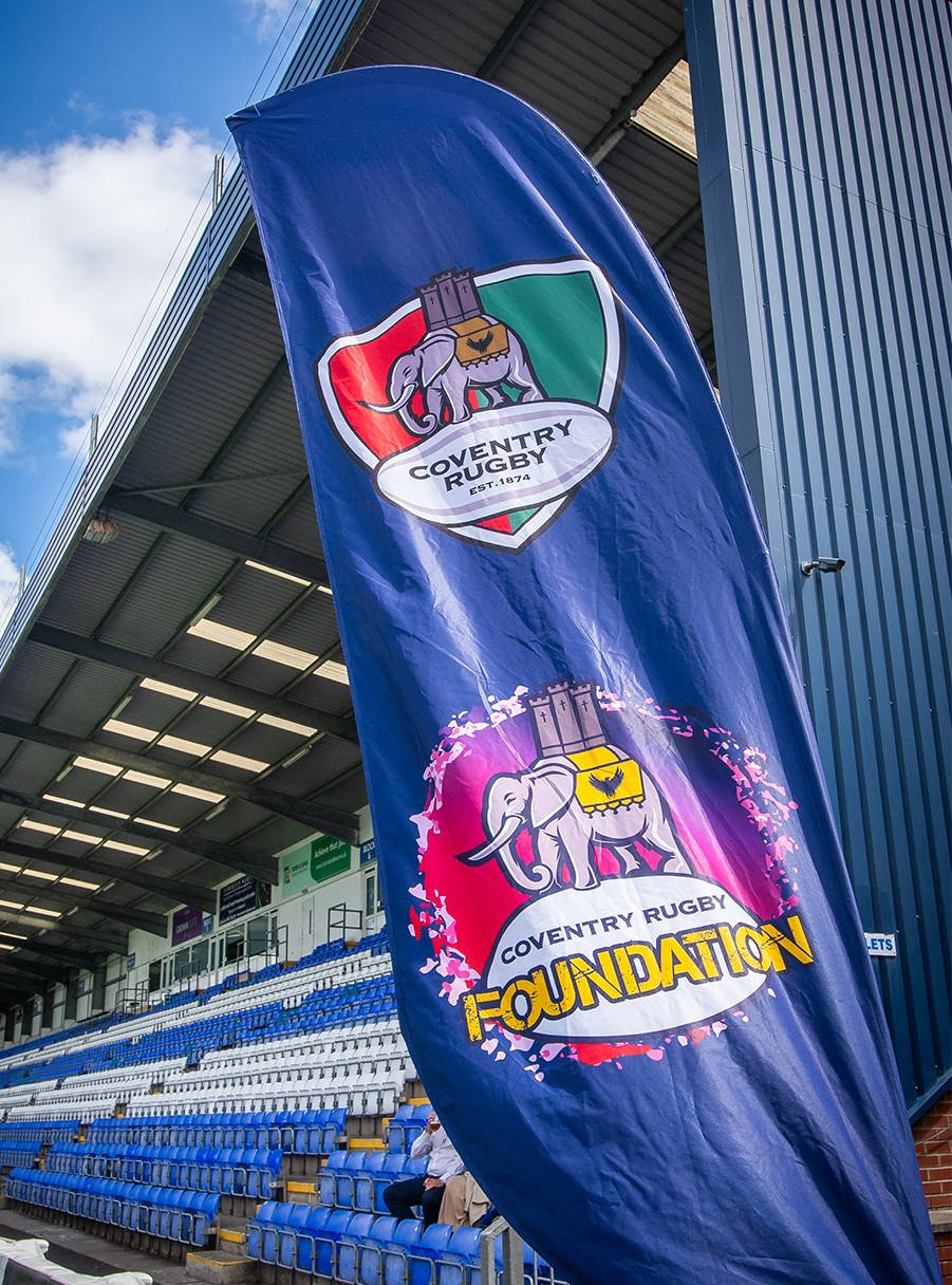 a soccer goal in a field with a blue sky in the background