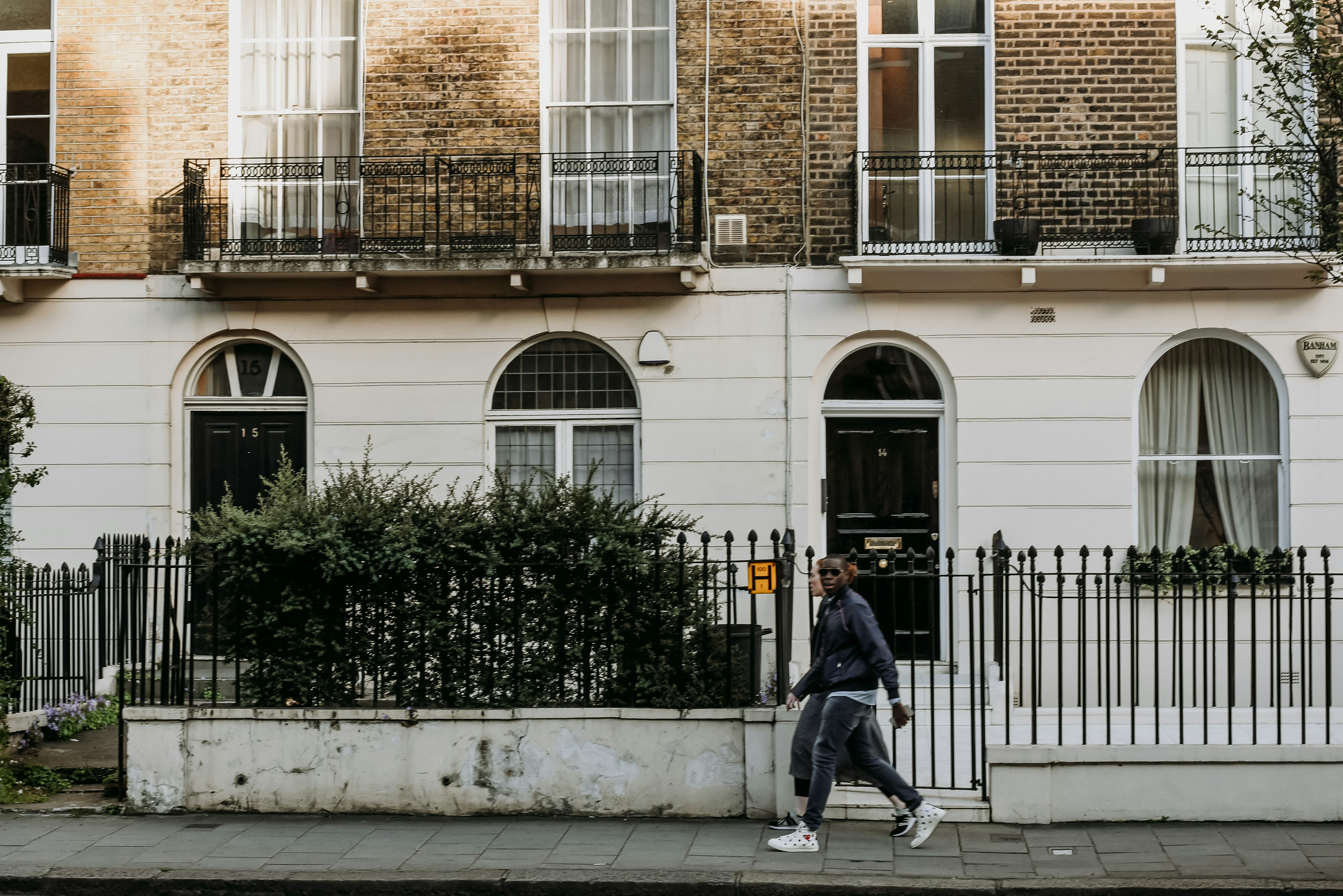 a man walking down the street in front of a building