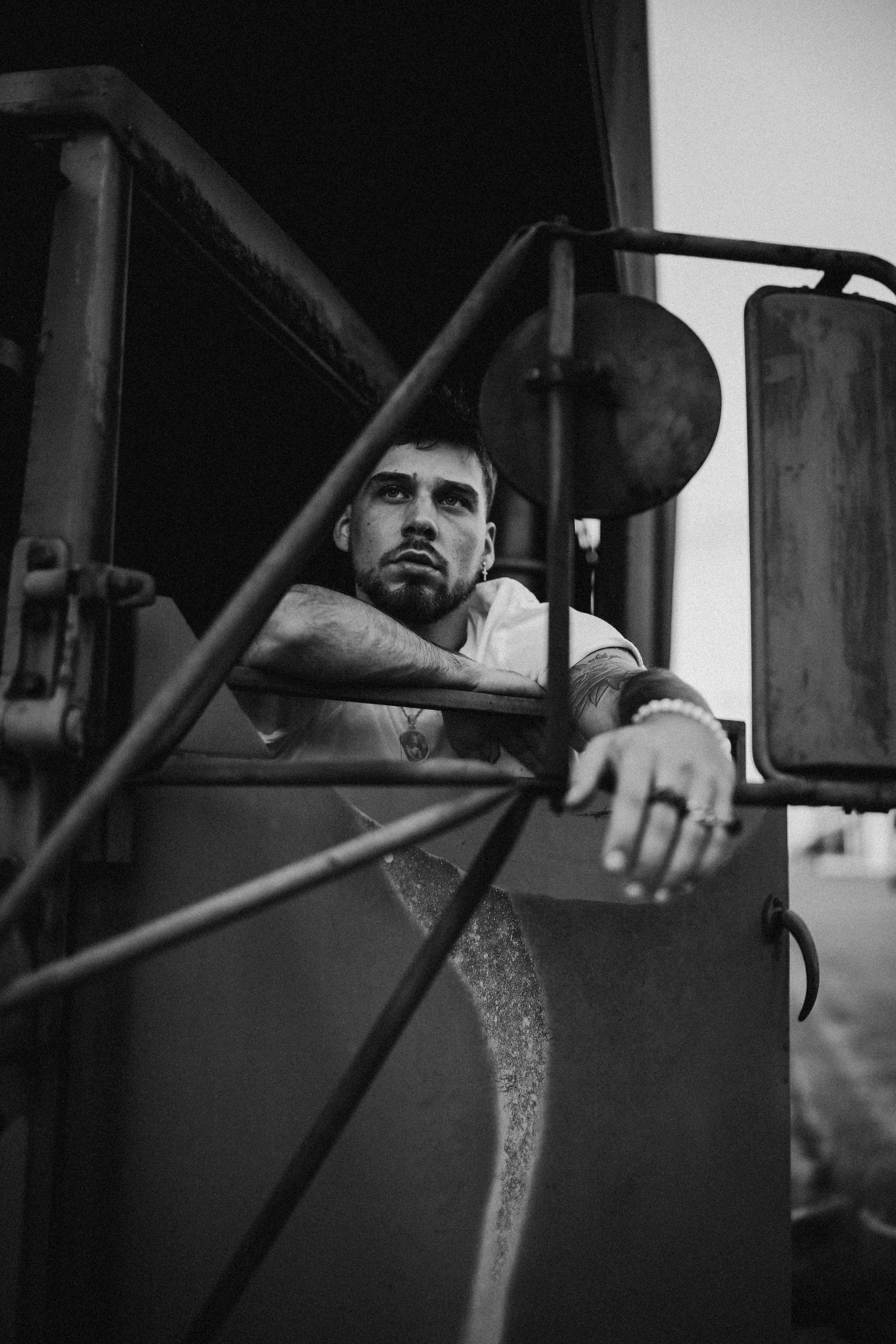 Black and white portrait of a trucker sitting in his truck