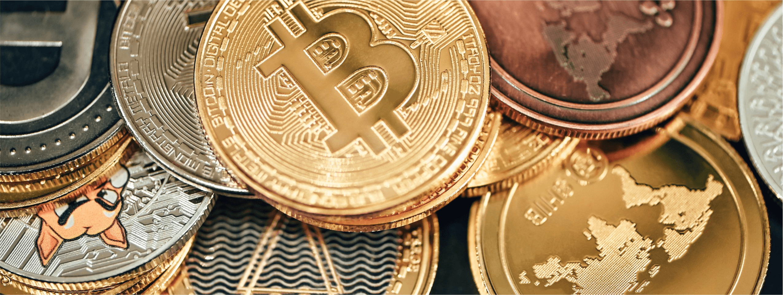 Various cryptocurrency coins piled together - Crypto Coins vs Tokens