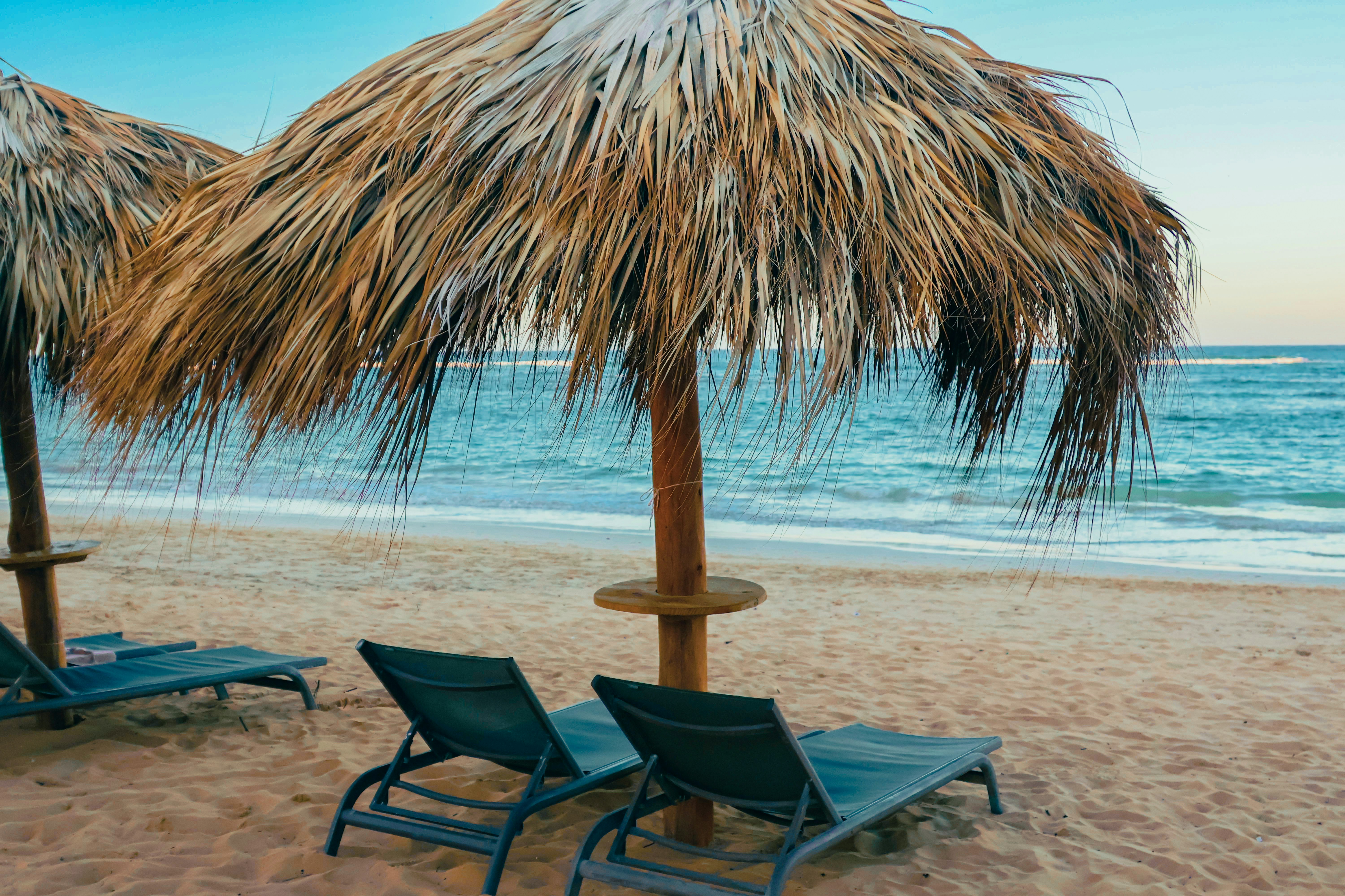 Tropical beach with umbrellas and lounge chairs.