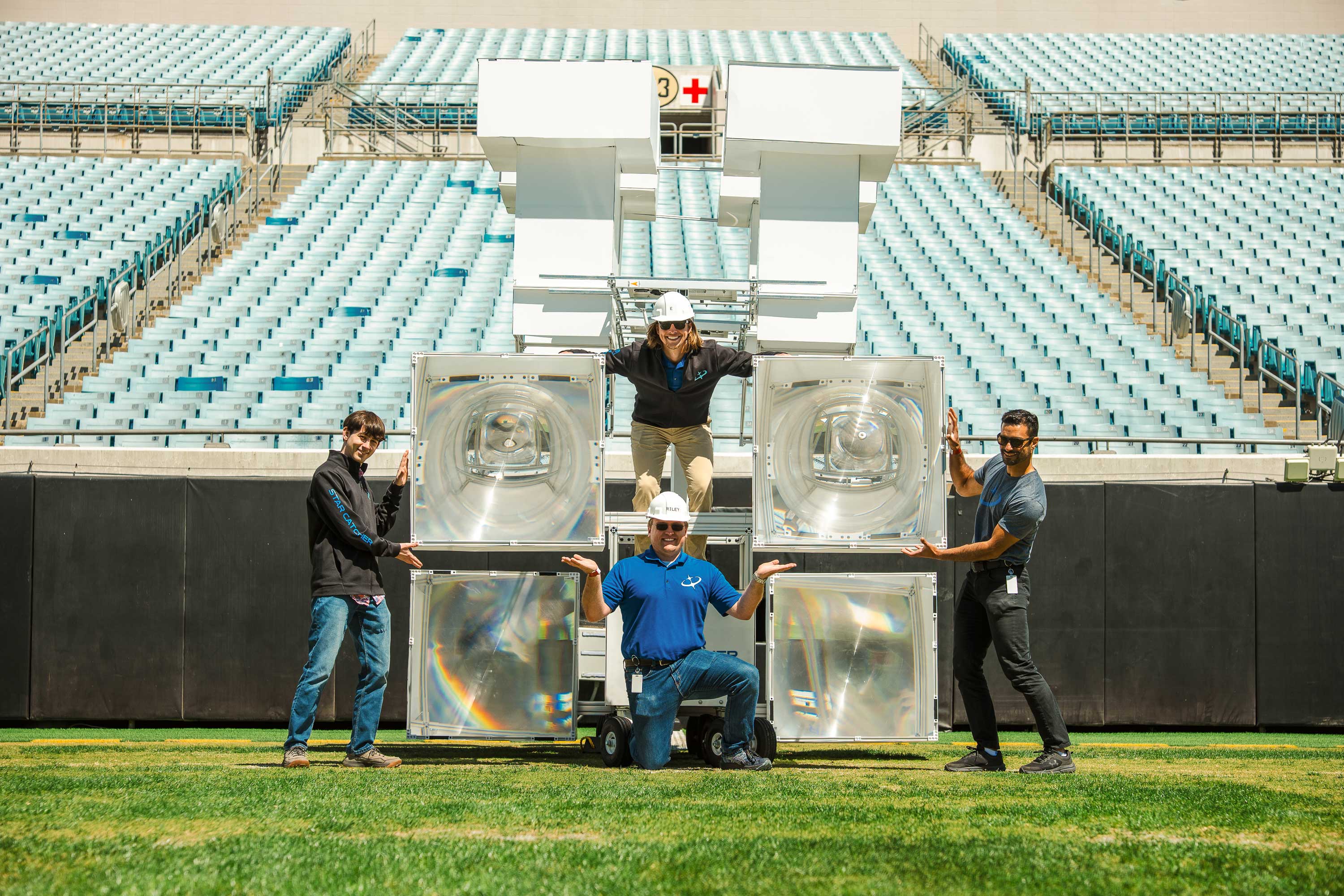 Star Catcher optics team with fresnel lens hardware at EverBank Stadium after successful first public demo