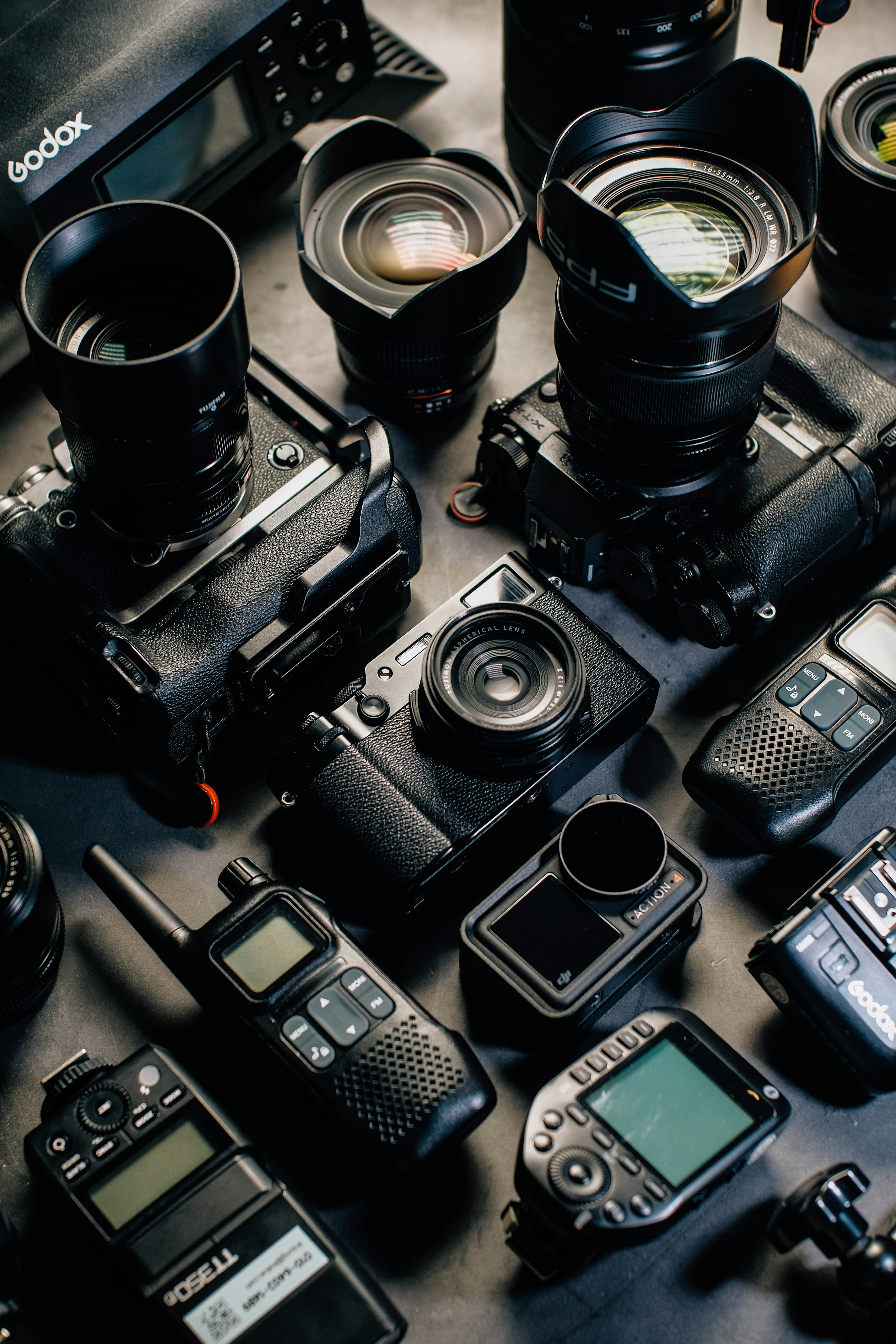 Collection of cameras, lenses, and radio equipment.