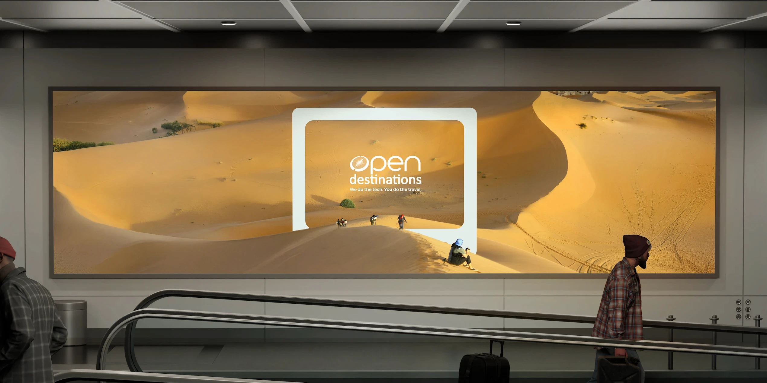 Airport walkway billboard for Open Destinations featuring travellers in desert sand dunes. The ad reads: “We do the tech. You do the travel.”