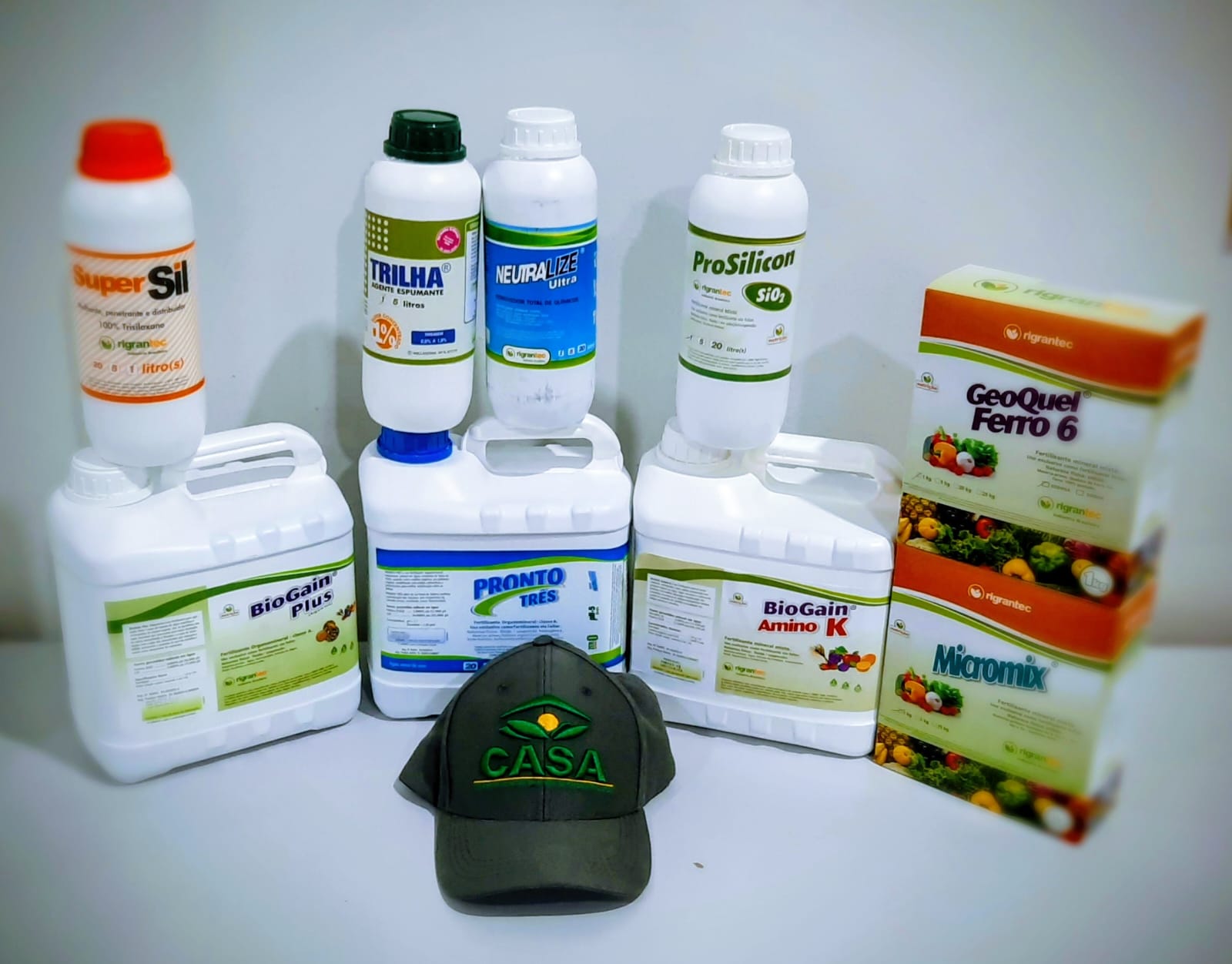 person in gray hoodie holding red and white box