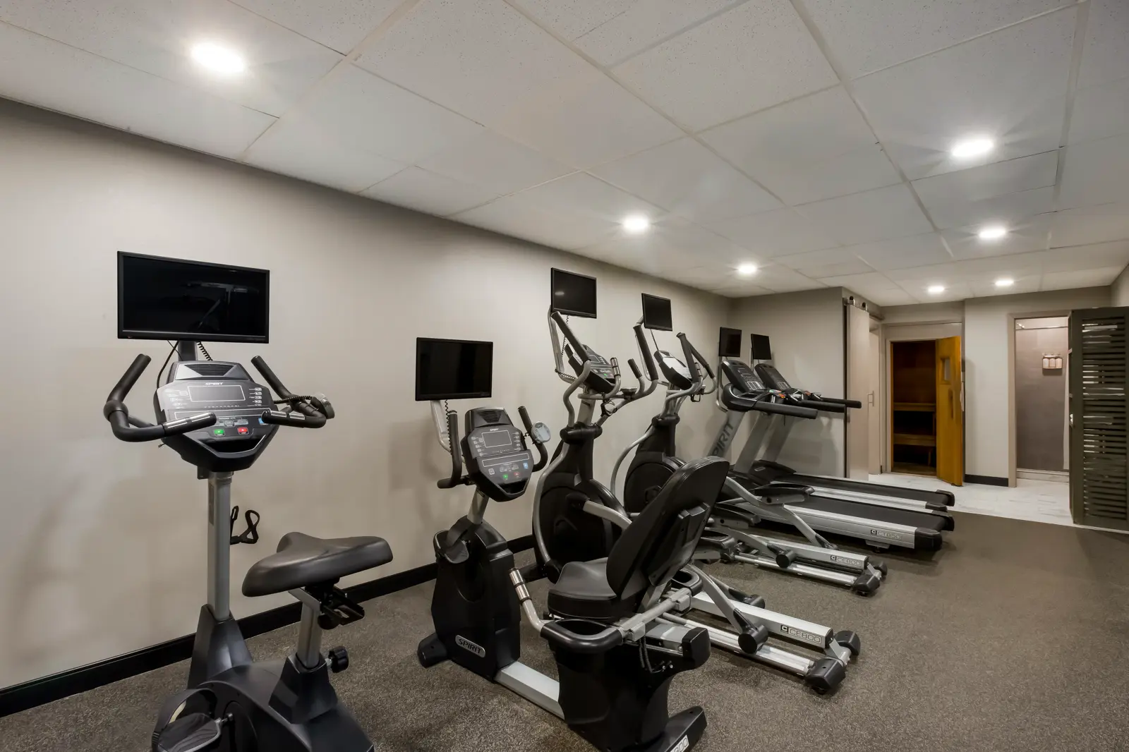 Modern gym with cardio machines, free weights, and functional training gear.
