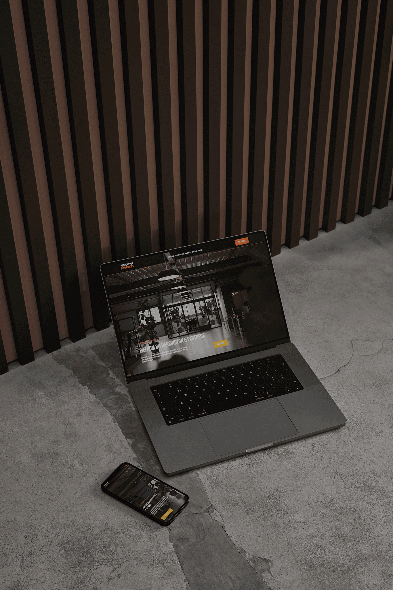 Shot of a laptop and phone laying on the ground with a website open