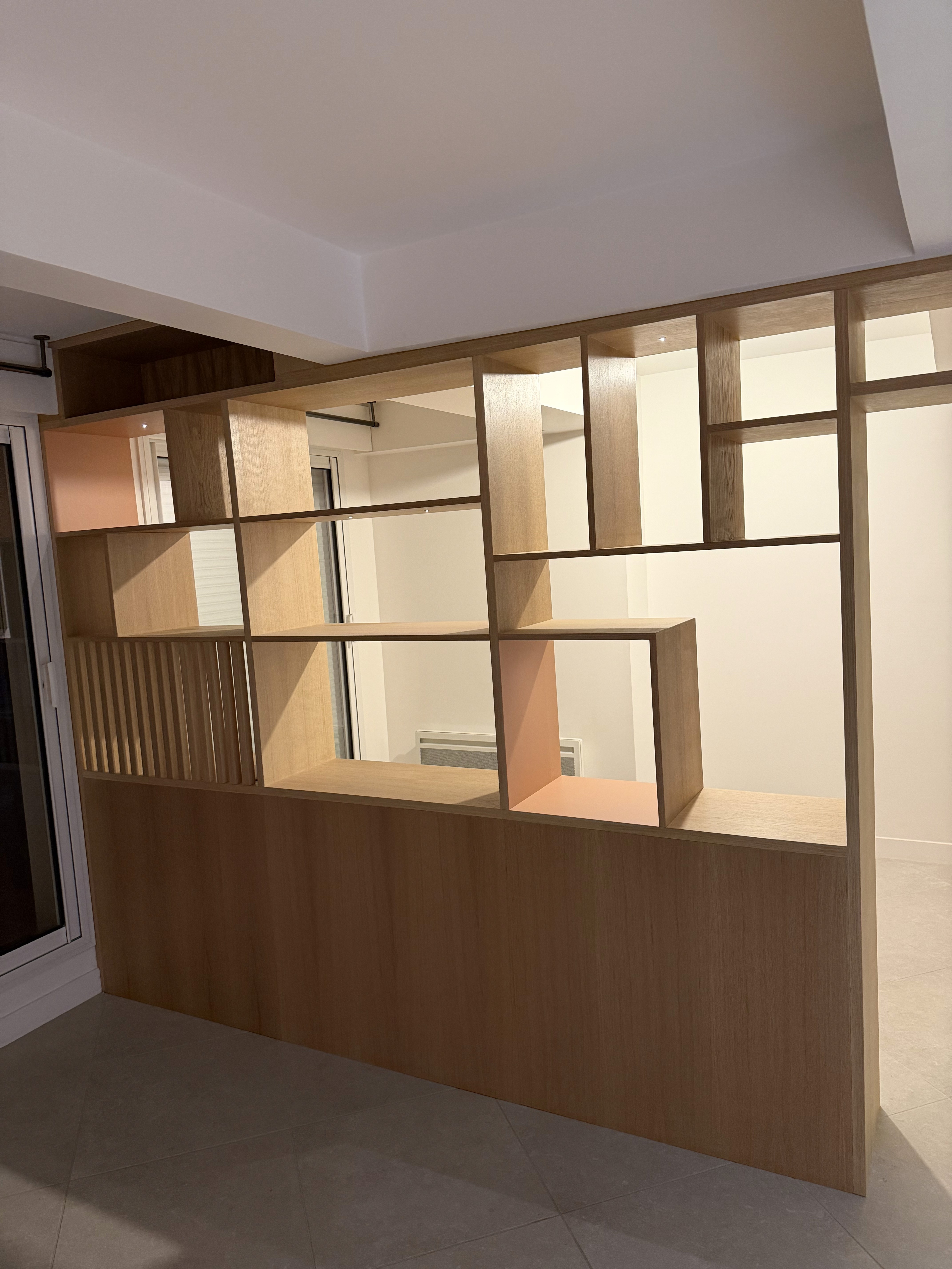 A room with some books a couch and chair light interior