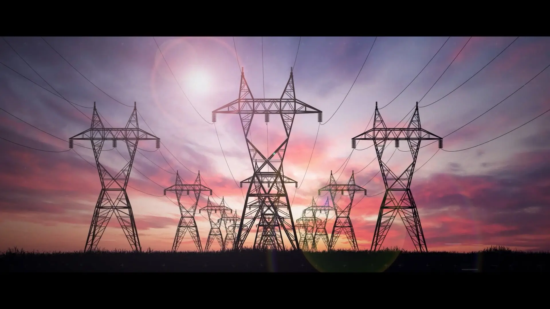 High-voltage electricity pylons stretching across a landscape at sunset, representing large-scale energy transmission networks.