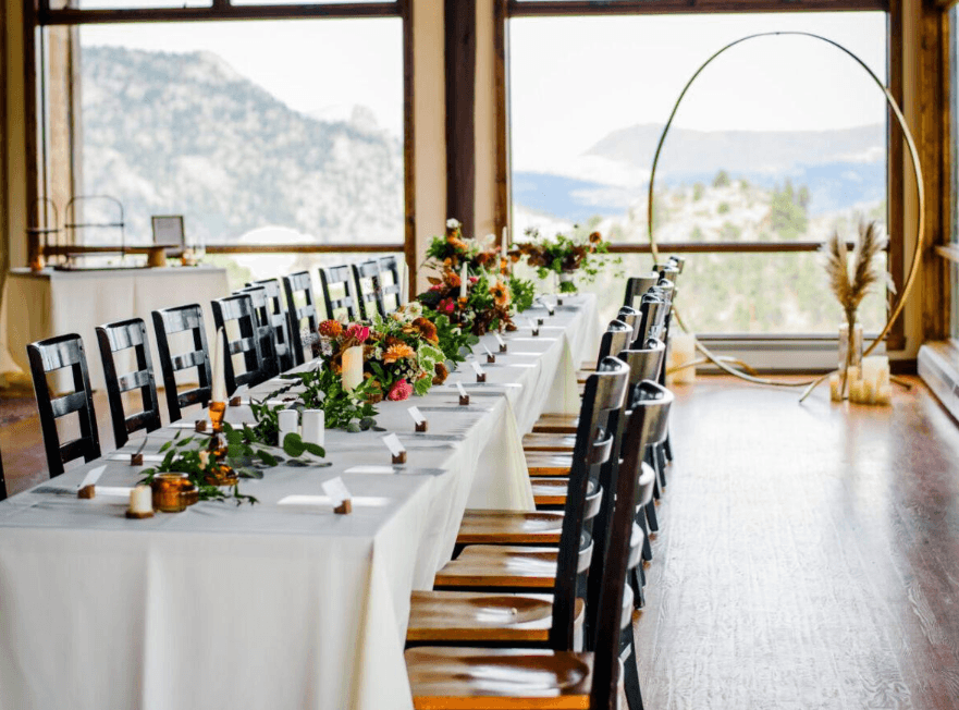 Wedding reception table setup at Twin Owls Steakhouse with rustic decor and mountain views.
