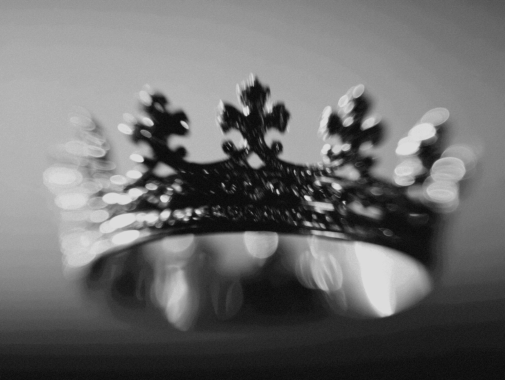 A striking shot of a decorative crown floating against a dark background