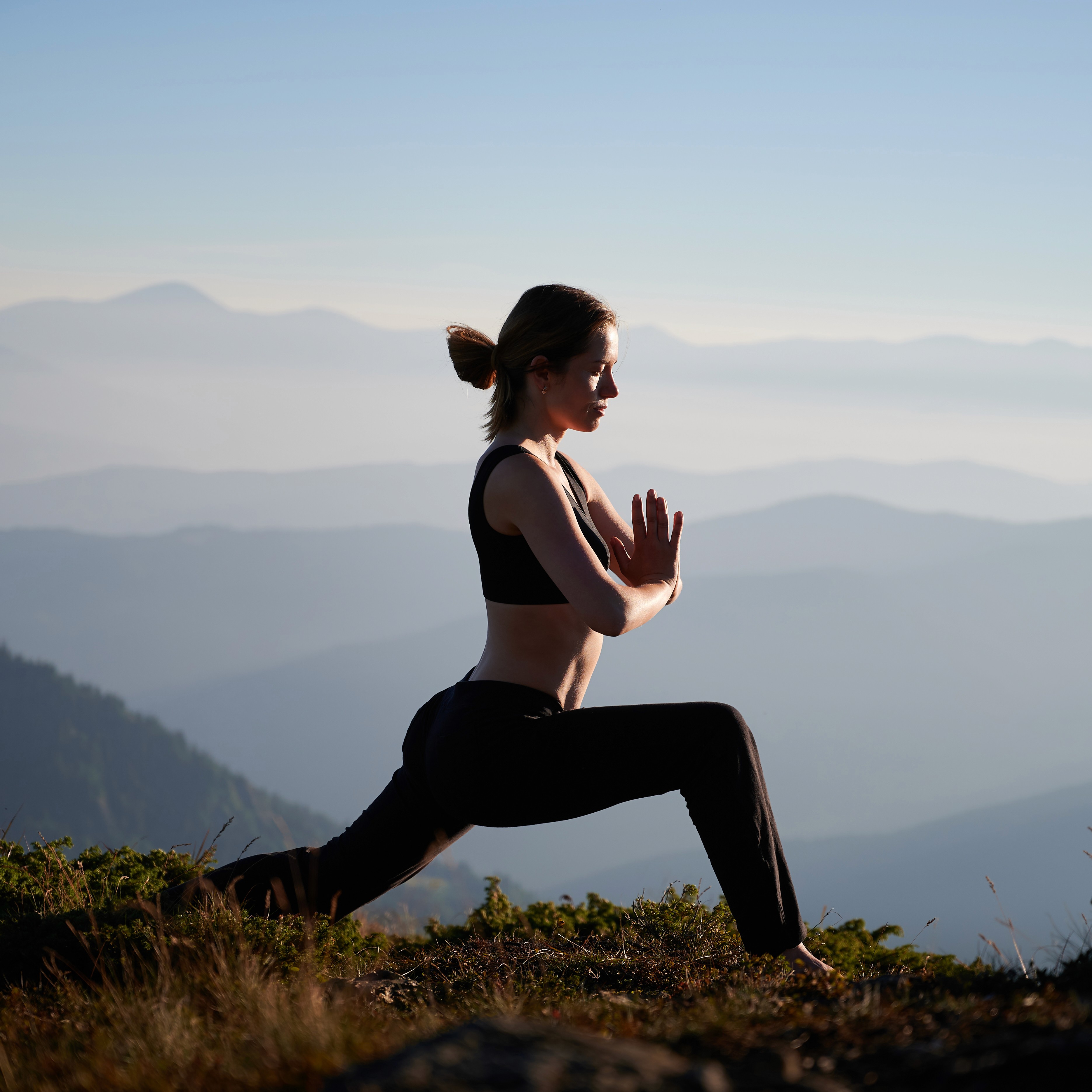 Woman doing yoga in the mountains