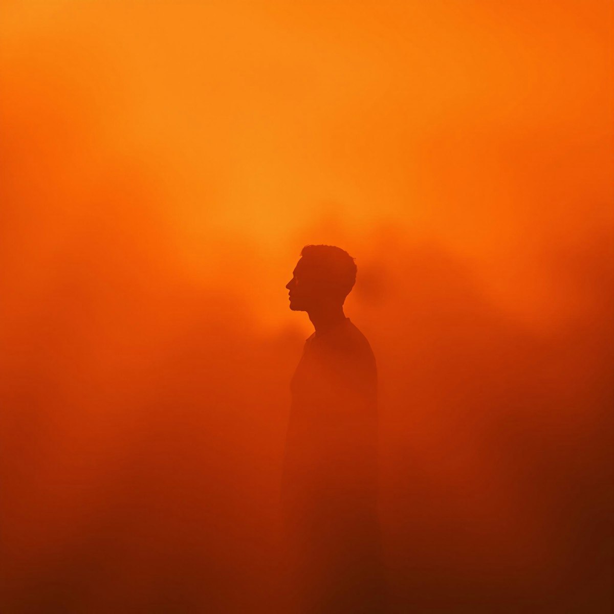 Man in fur hat hiding face with scarf at night.