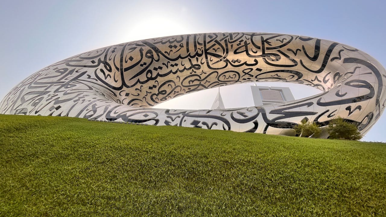 The Museum of the Future in Dubai, with a distinct calligraphy design seen from a green lawn.&nbsp;
