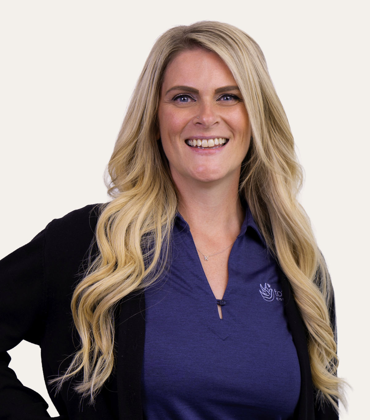 Blonde woman smiling at the camera.