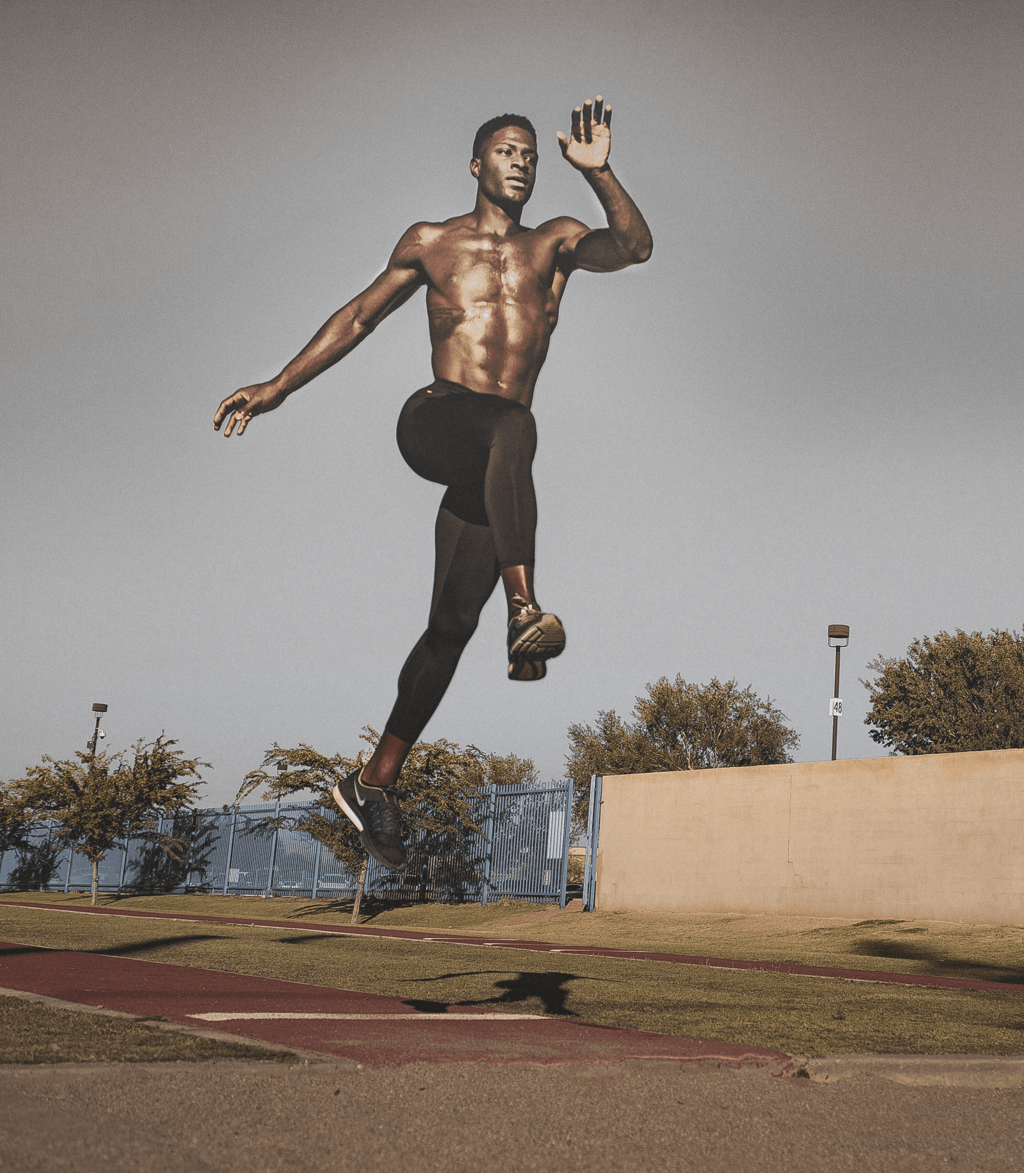 a man standing on a tennis court holding a ball