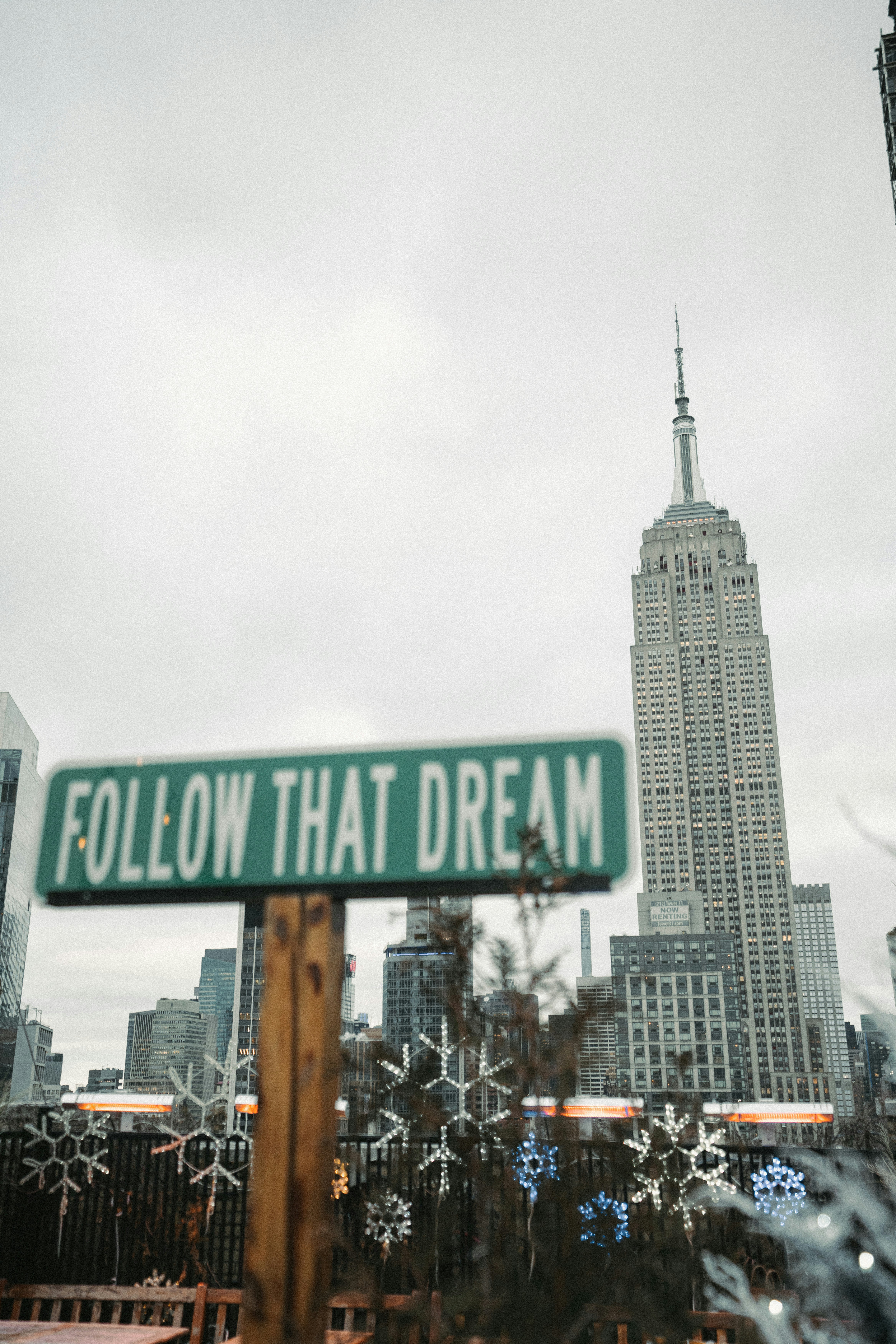 a street sign that reads follow that dream