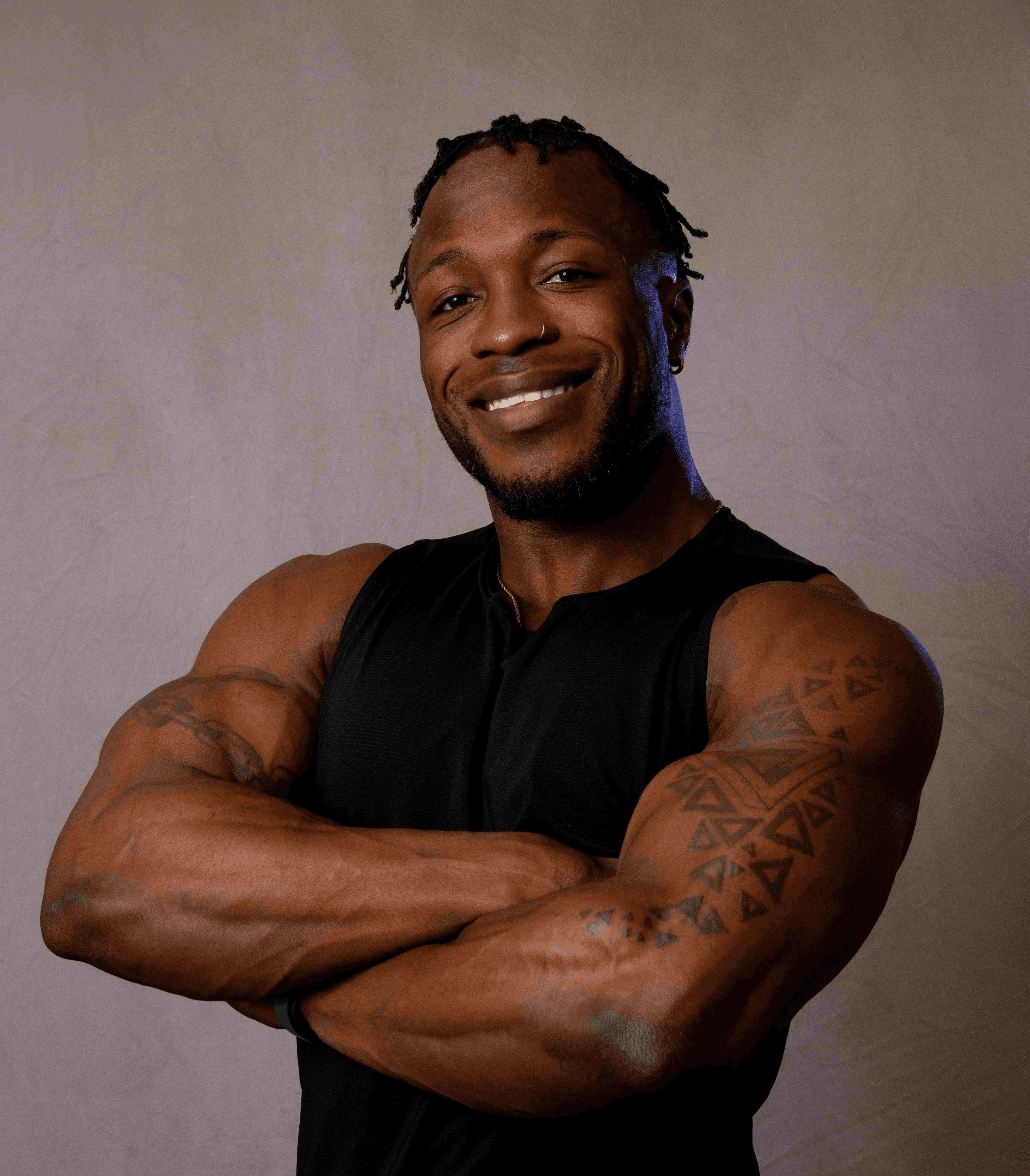 Strong man with muscles and tattoos smiling