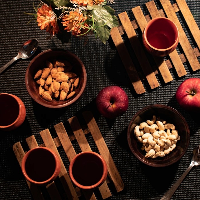 Apple beside bowl of nuts
