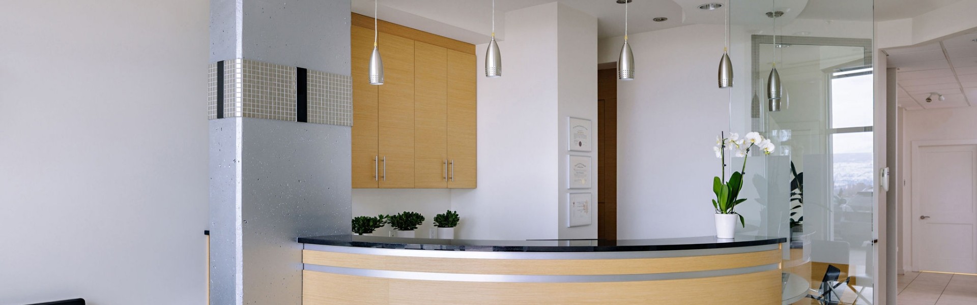 Alpha Dental office reception area with wooden desk and decorative lighting.