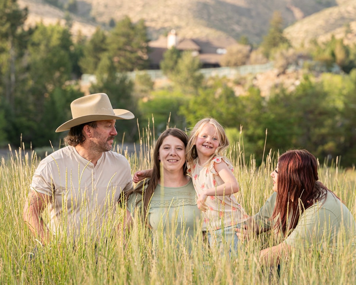 A family standing together in a field