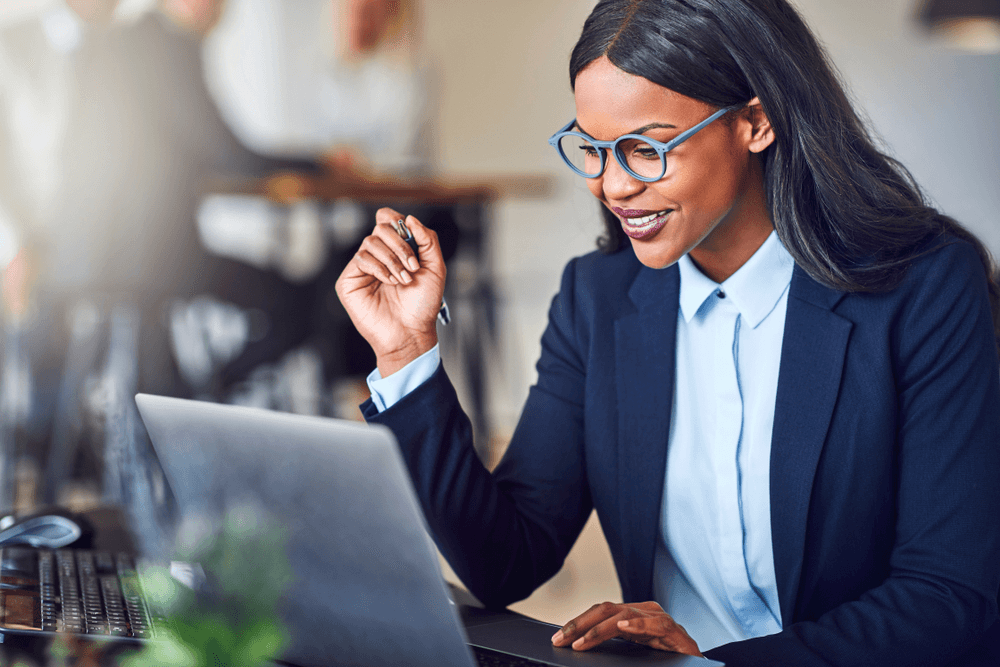 Close-up of lush, dark green leaves, some glossy and wet, against a muted background.