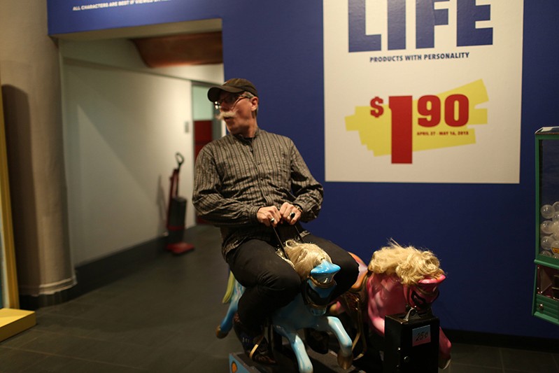 a man riding plastic horse