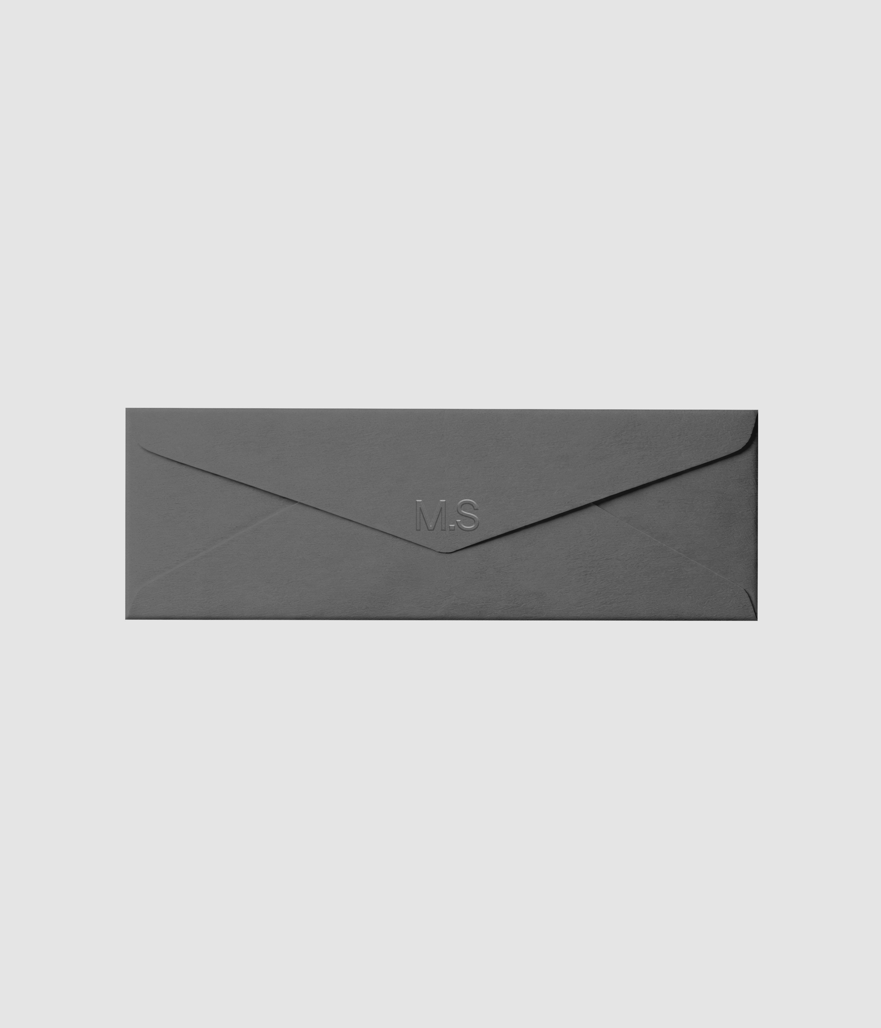 Gray horizontal envelope branding mockup with embossed logo effect on white background on Mockups Supply