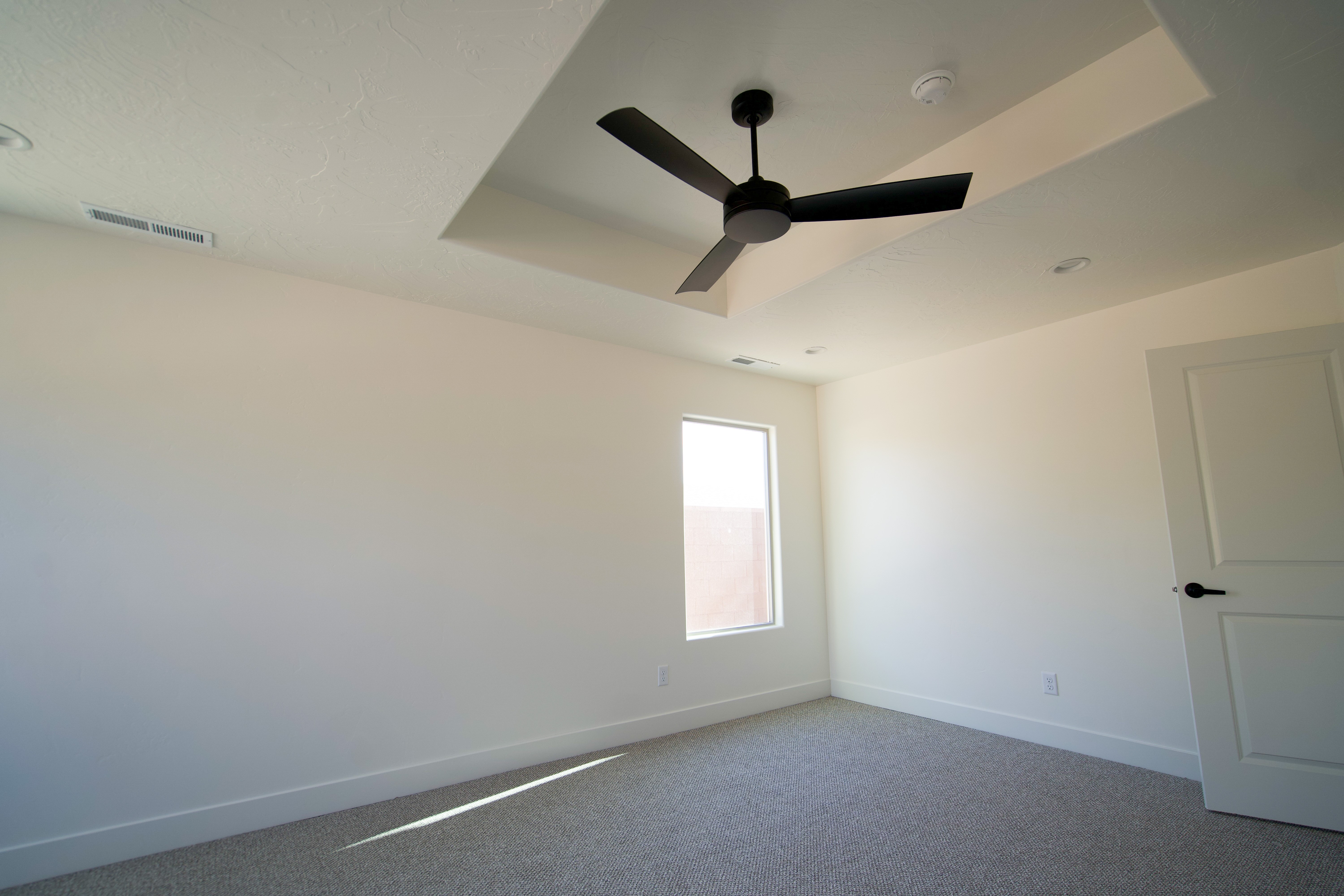 Bedroom in a Hurricane, Utah remodel with light finishes and natural lighting.