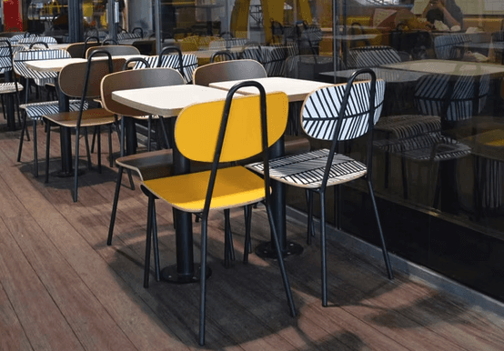 a room with a table, chairs, and a partition